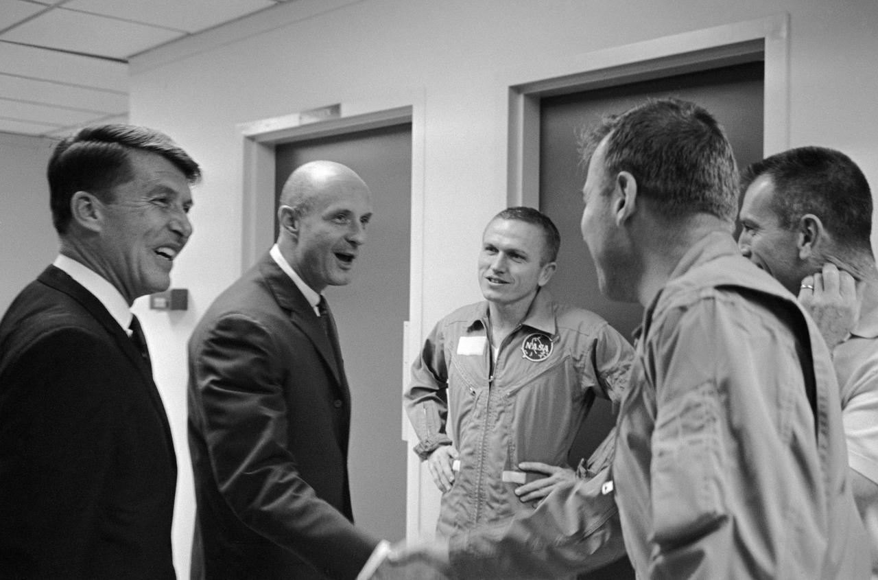 S65-66728 (19 Dec. 1965) --- This happy round of handshakes took place in the Manned Spacecraft Operations Building crew quarters, Merritt Island, as the Gemini-6 crew (left) welcomed the Gemini-7 crew back to the Kennedy Space Center. Left to right, are astronauts Walter M. Schirra Jr., Gemini-6 command pilot; Thomas P. Stafford, Gemini-6 pilot; Frank Borman, Gemini-7 command pilot; James A. Lovell Jr., Gemini-7 pilot; and Donald K. Slayton (partially hidden behind Lovell), assistant director for Flight Crew Operations, Manned Spacecraft Center, Houston. Photo credit: NASA