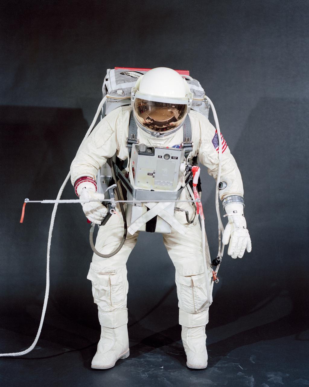 S66-17480 (18 Jan. 1966) --- Test subject Fred Spress, Crew Systems Division, wears the spacesuit and extravehicular equipment planned for use by astronaut David R. Scott. The helmet is equipped with a gold-plated visor to shield the astronaut's face from unfiltered sun rays. The system is composed of a life support pack worn on the chest and a support pack worn on the back. Photo credit: NASA