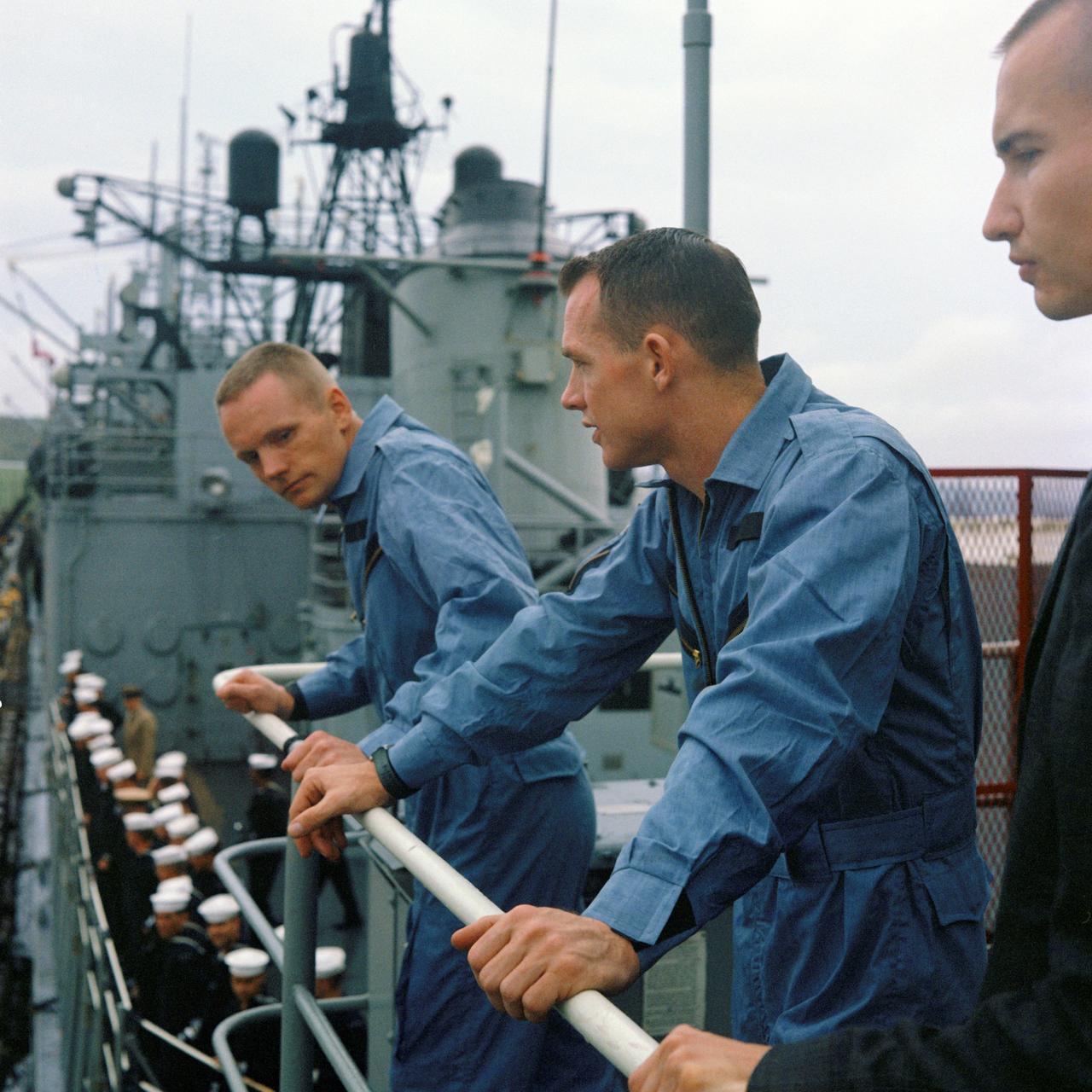 S66-18609 (17 March 1966) --- Astronauts David R. Scott (left), Gemini-8 pilot, and Neil A. Armstrong, command pilot, stand on the deck of the destroyer USS Leonard F. Mason upon its arrival at Nahs, Okinawa. Photo credit: NASA