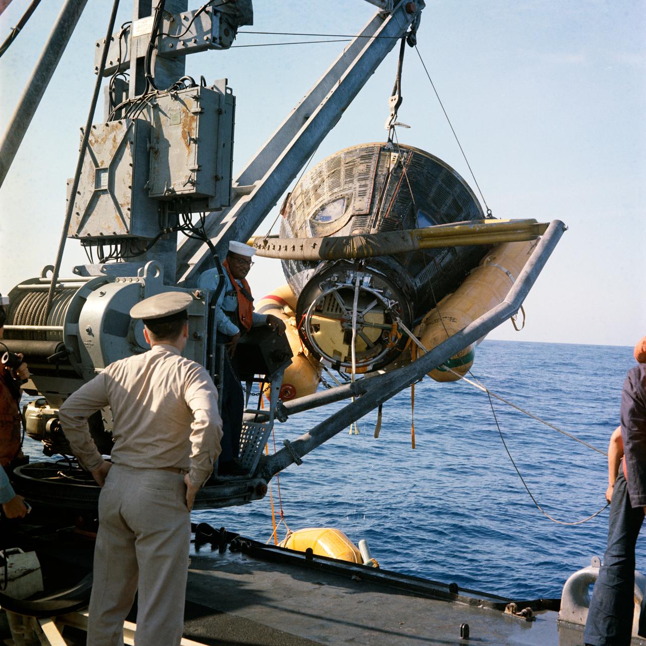 S66-18613 (16 March 1966) --- The Gemini-8 spacecraft, with astronauts Neil A. Armstrong and David R. Scott still aboard, is hoisted aboard the destroyer USS Leonard F. Mason. Trouble with the Gemini-8 Orbit Attitude and Maneuvering System (OAMS) forced an early termination of the mission. Photo credit: NASA