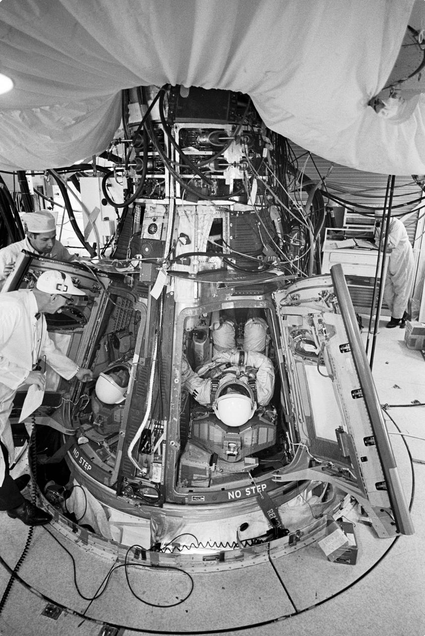 S66-24403 (16 March 1966) --- Astronauts David R. Scott and Neil A. Armstrong inserted into Gemini-8 spacecraft prior to liftoff. Photo credit: NASA