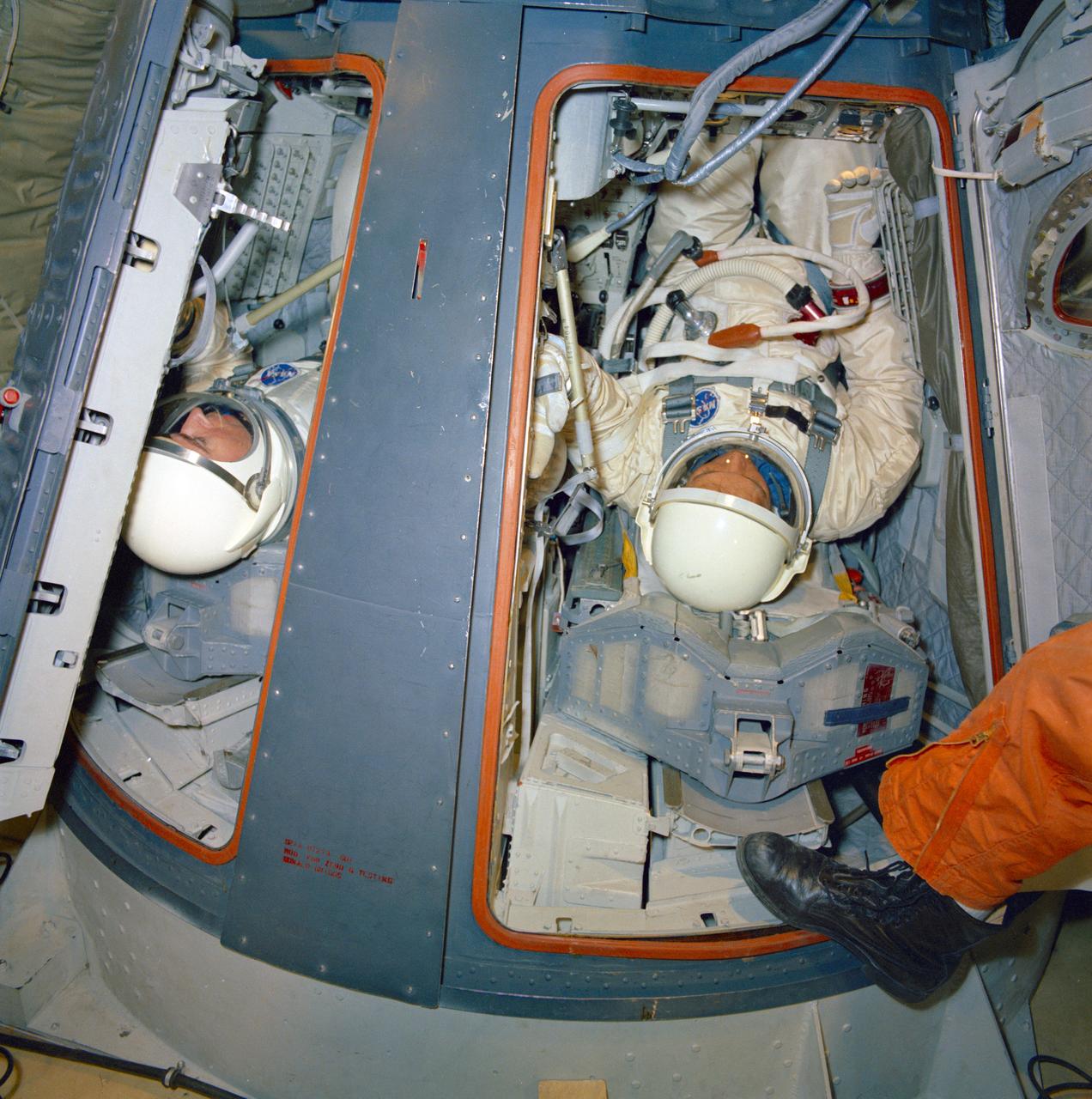 S66-28583 (1 April 1966) --- The Gemini-10 prime crew undergoes zero-gravity egress training aboard a KC-135 Air Force plane. Astronaut John W. Young, command pilot, is on left. On the right is astronaut Michael Collins, pilot. The airplane, flying a parabolic curve, creates a weightless environment as a training exercise in preparation for spaceflight Photo credit: NASA