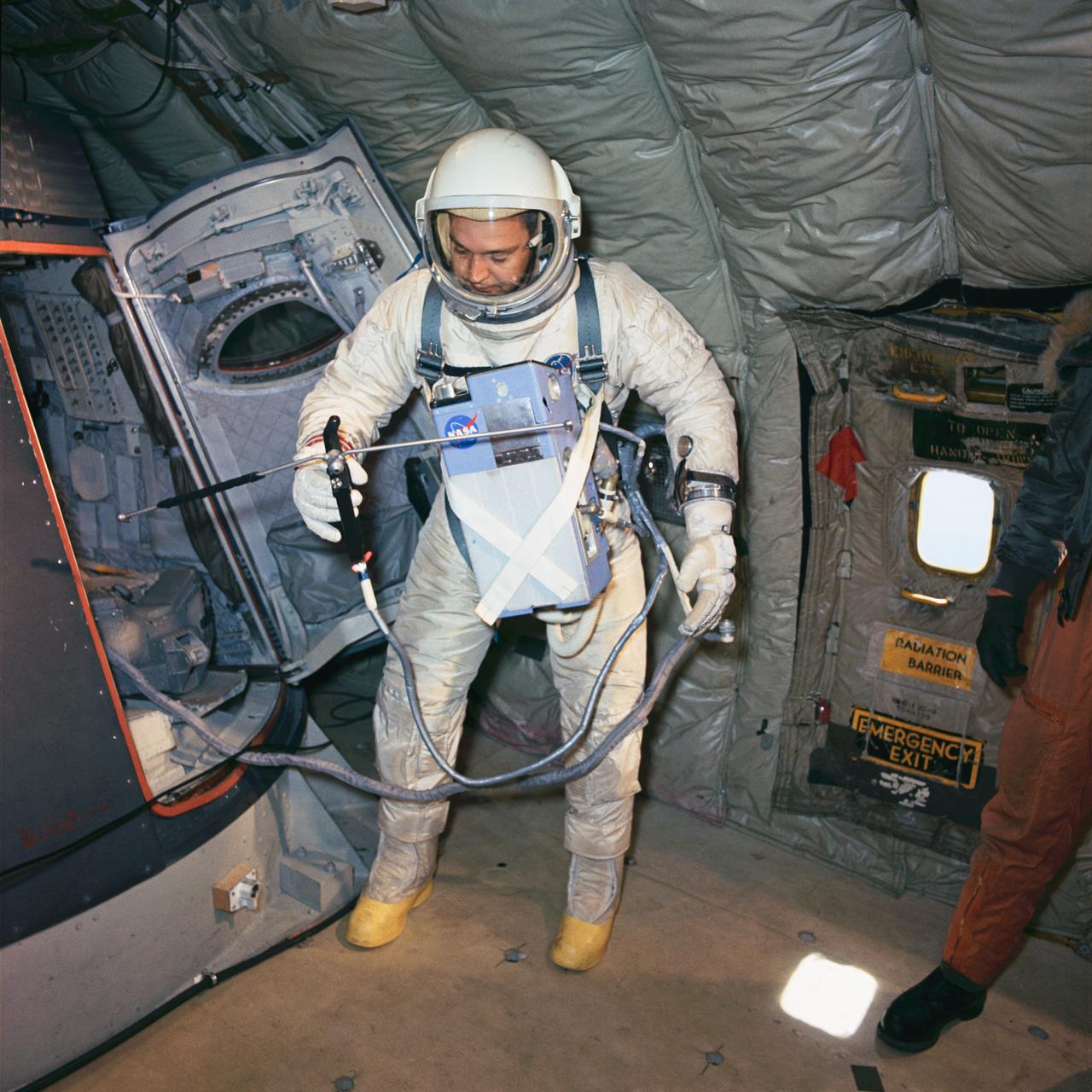 S66-28636 (1 April 1966) --- Astronaut Clifton C. Williams Jr., backup crew pilot of the Gemini-10 spaceflight, undergoes zero-gravity egress training. A KC-135 Air Force plane, flying a parabolic curve, creates a weightless environment as a training exercise in preparation for spaceflight. The Hand-Held Maneuvering Unit in his right hand produces controlled thrust for moving about. Photo credit: NASA