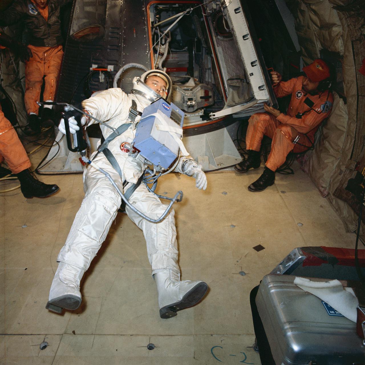 S66-28782 (1 April 1966) --- Astronaut Michael Collins, prime crew pilot of the Gemini-10 spaceflight, experiences a condition of weightlessness during zero-gravity egress training. A KC-135 Air Force plane, flying a parabolic curve, creates a weightless environment as a training exercise in preparation for spaceflight. The Hand-Held Maneuvering Unit in his right hand produces controlled thrust for moving about. Photo credit: NASA