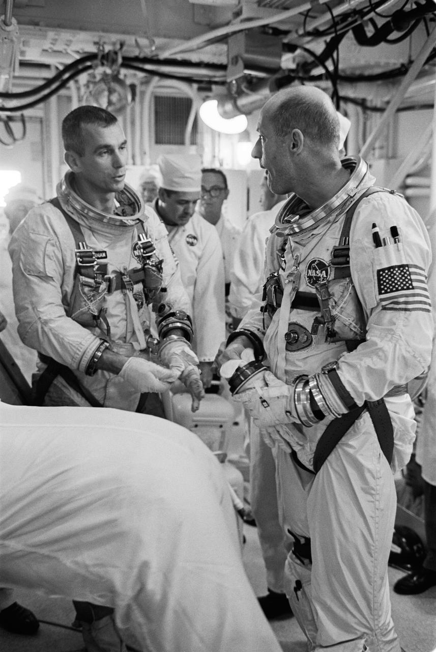 S66-32044 (17 May 1966) --- Astronauts Eugene A. Cernan (left), pilot, and Thomas P. Stafford, command pilot, discuss the postponed Gemini-9 mission just after egressing their spacecraft in the white room atop Pad 19. The Agena Target Vehicle failed to achieve orbit, causing a termination of the mission. The spaceflight (to be called Gemini-9A) has been rescheduled for May 31. A Gemini Augmented Target Docking Adapter will be used as the rendezvous and docking vehicle for the Gemini-9 spacecraft. Photo credit: NASA