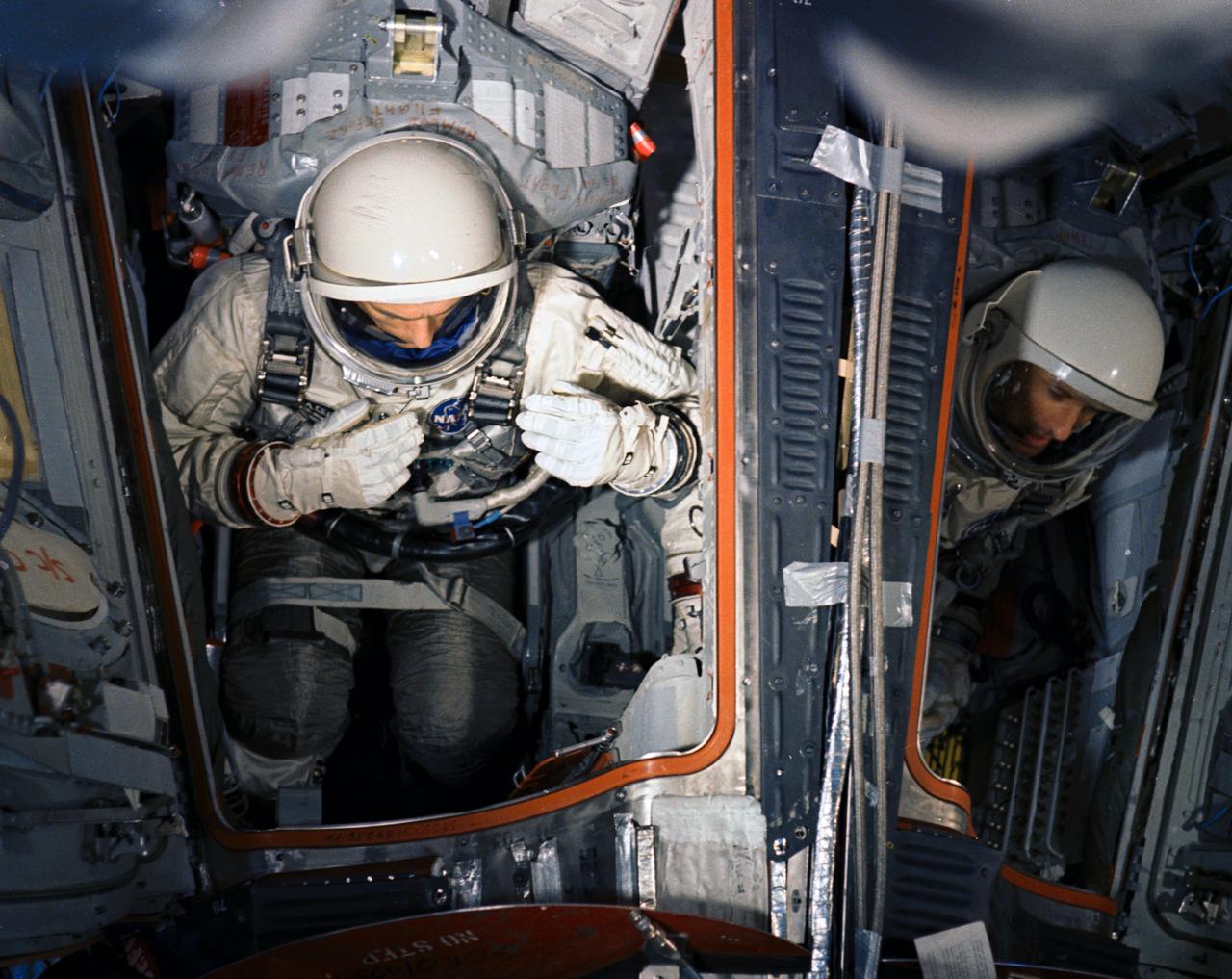 S66-33406 (10 May 1966) --- Astronaut Thomas P. Stafford (on left), command pilot, and Eugene A. Cernan, pilot, in Gemini-9 spacecraft in the white room at Pad 19 during a Gemini-9/Agena simultaneous launch demonstration. This test is a coordinated dountdown of the Atlas-Agena and the Gemini-Titan vehicles. Photo credit: NASA