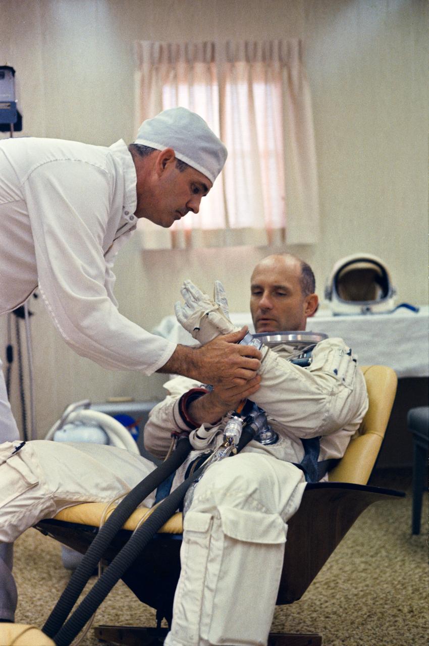 S66-33408 (10 May 1966) --- Astronaut Thomas P. Stafford, command pilot of the National Aeronautics and Space Administration's Gemini-9 spaceflight, sits in Launch Complex 16 suiting trailer while suiting up for a Gemini-9/Agena simultaneous launch demonstration. This test is a coordinated countdown of the Atlas-Agena and the Gemini-Titan vehicles. A suit technician assists Stafford. Photo credit: NASA