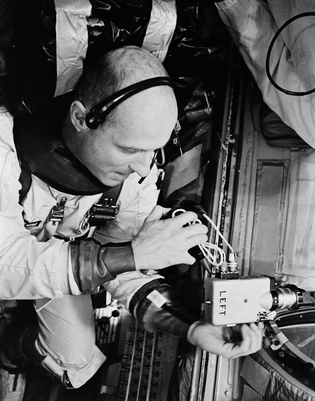 S66-33728 (10 May 1966) --- Astronaut Thomas P. Stafford, command pilot of the Gemini-9 spaceflight, checks the 16mm Mauer camera which will be used in space. The camera will record and document the exterior of the spacecraft and the Agena target vehicle in the docked configuration during the Gemini-9/Agena rendezvous and docking mission. Photo credit: NASA