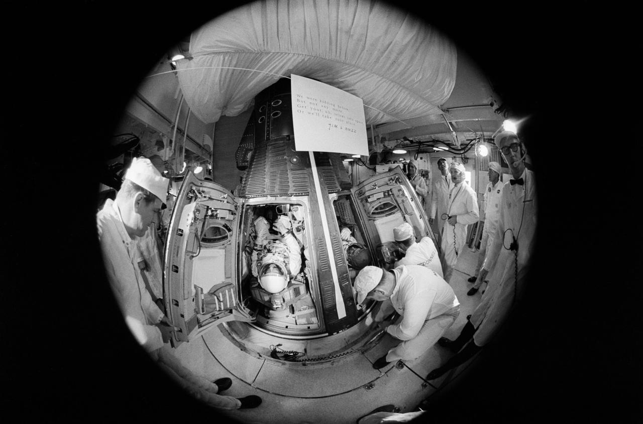 S66-34055 (3 June 1966) --- Fisheye camera lens view of the white room atop Pad 19 during the insertion of astronauts Thomas P. Stafford and Eugene A. Cernan into the Gemini-9A spacecraft. Minutes later the hatches were sealed on the spacecraft in preparation for launch of the proposed three-day mission. Photo credit: NASA