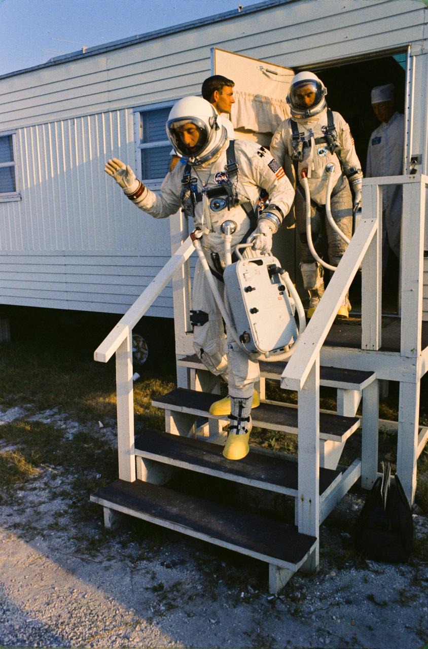 S66-34075 (3 June 1966) --- Prime crew for the Gemini-9A spaceflight, astronauts Thomas P. Stafford (front), command pilot, and Eugene A. Cernan, pilot, leave the suiting trailer at Launch Complex 16 in full spacesuits during prelaunch countdown. Photo credit: NASA