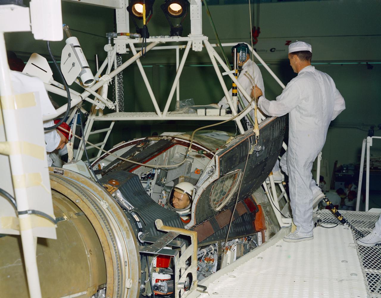 S66-34167 (21 April 1966) --- Astronauts John W. Young (right), command pilot, and Michael Collins, pilot, the prime crew of the Gemini-10 spaceflight, prepare for a Manned Altitude Test Run in the Gemini-10 spacecraft. They are in McDonnell Aircraft's 30-foot altitude chamber. Photo credit: NASA