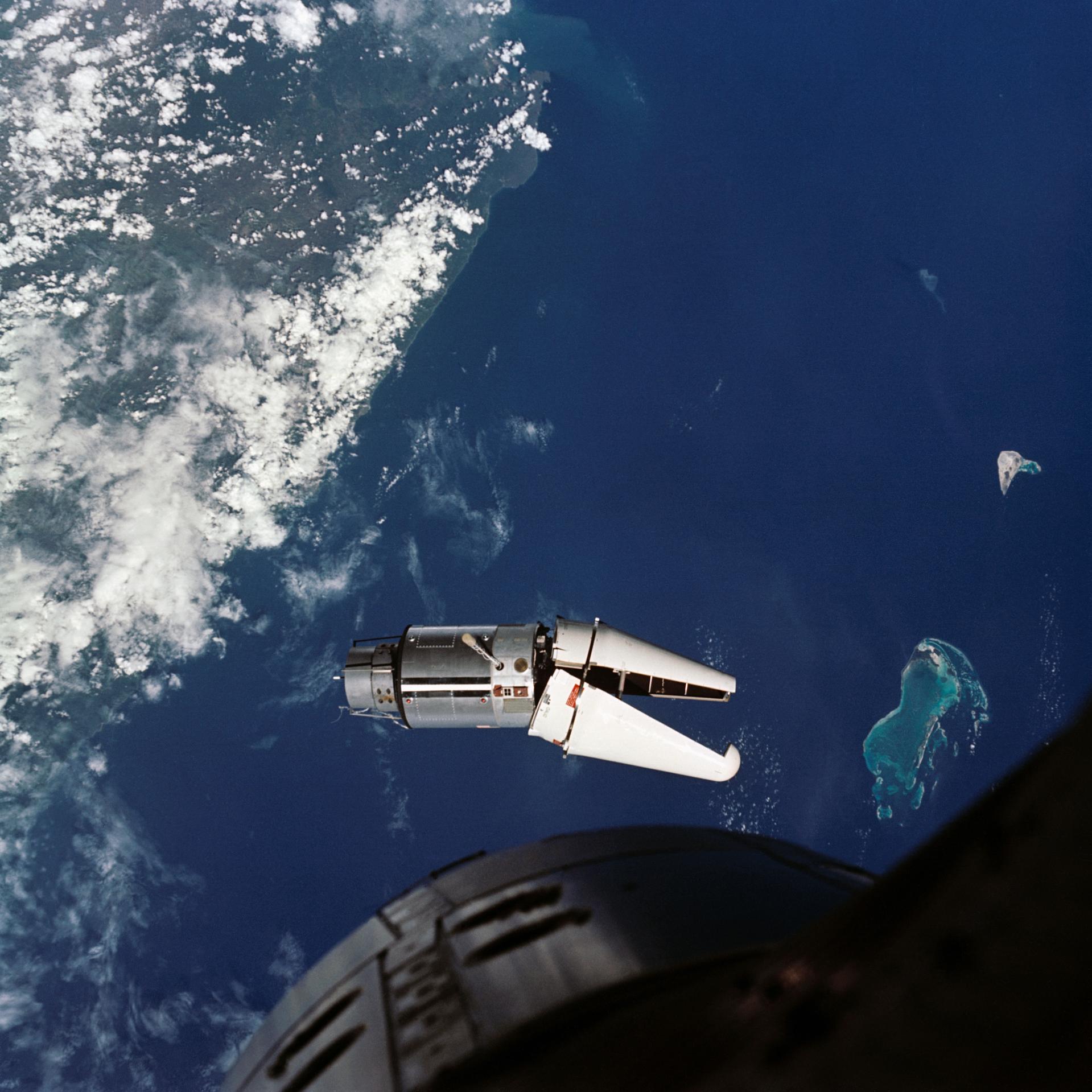 The Agena target vehicle is seen in orbit over the Earth