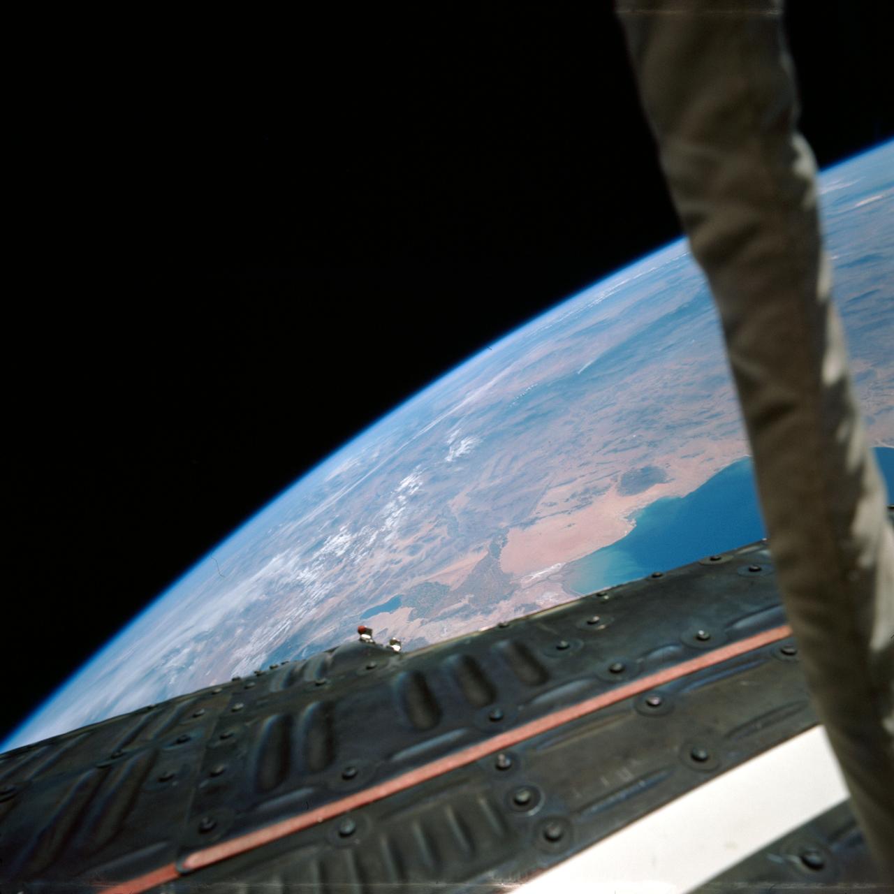 S66-38068 (5 June 1966) --- Astronaut Eugene A. Cernan took this view of the Gemini-9A spacecraft and his umbilical cord (right) over California, Arizona, and Sonora, Mexico, during his extravehicular activity (EVA) on the Gemini-9A mission. Taken during the 32nd revolution of the flight. Photo credit: NASA