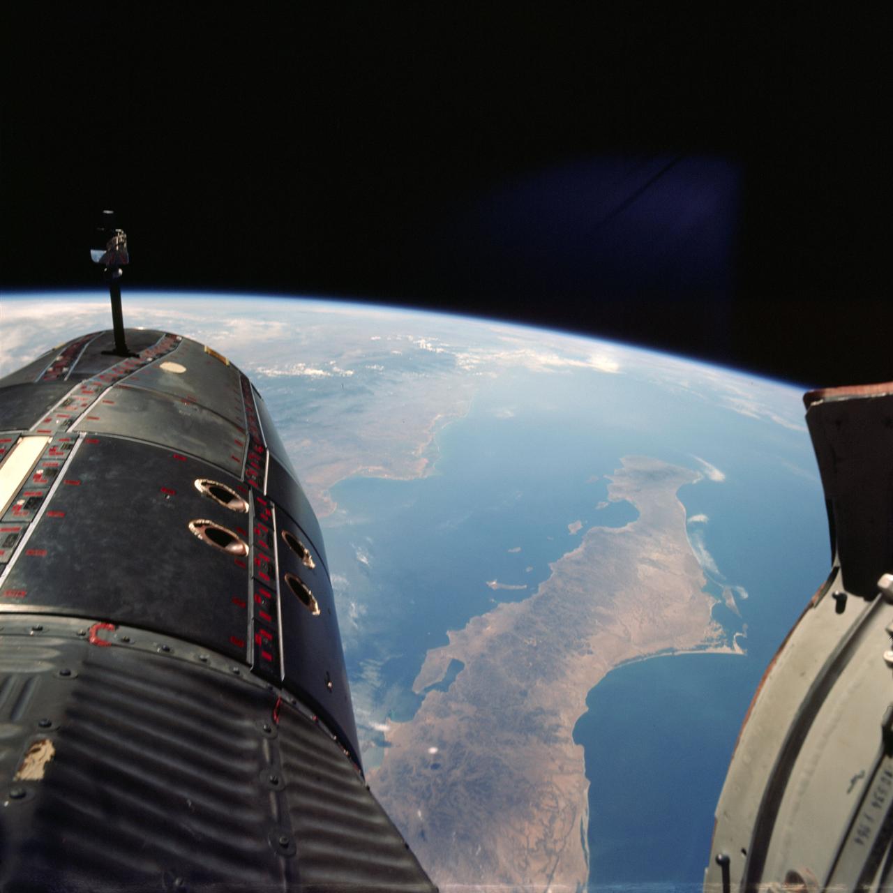 S66-38070 (5 June 1966) --- Northwestern Mexico as seen from the Gemini-9A spacecraft during its 32nd revolution of Earth. The large penisula is Baja California. The body of water at lower right is the Pacific Ocean. The land mass at upper left is the State of Sonora. The Gulf of California separates Sonora from the peninsula. The nose of the spacecraft is at left; and at right is the open hatch of the spacecraft. Astronaut Eugene A. Cernan, pilot, took this picture with his modified 70mm Hasselblad EVA camera, using Eastman Kodak, Ektachrome, MS (S.O. 217) color film. Photo credit: NASA