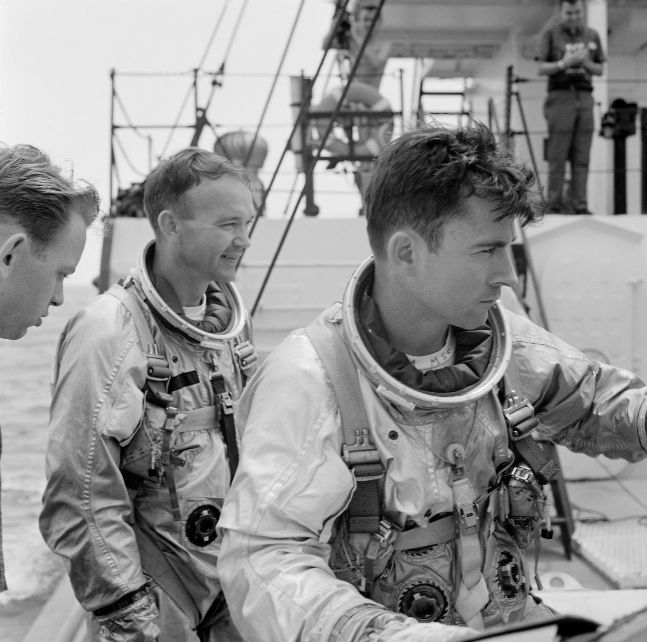S66-39473 (18 June 1966) --- Gemini-10 prime crew members, astronaut Michael Collins (left), pilot, and John W. Young, command pilot, onboard the NASA Motor Retriever during water egress training activity. The training is in preparation for the planned three-day spaceflight of Gemini-10. At left is suit technician William Haskell. Photo credit: NASA