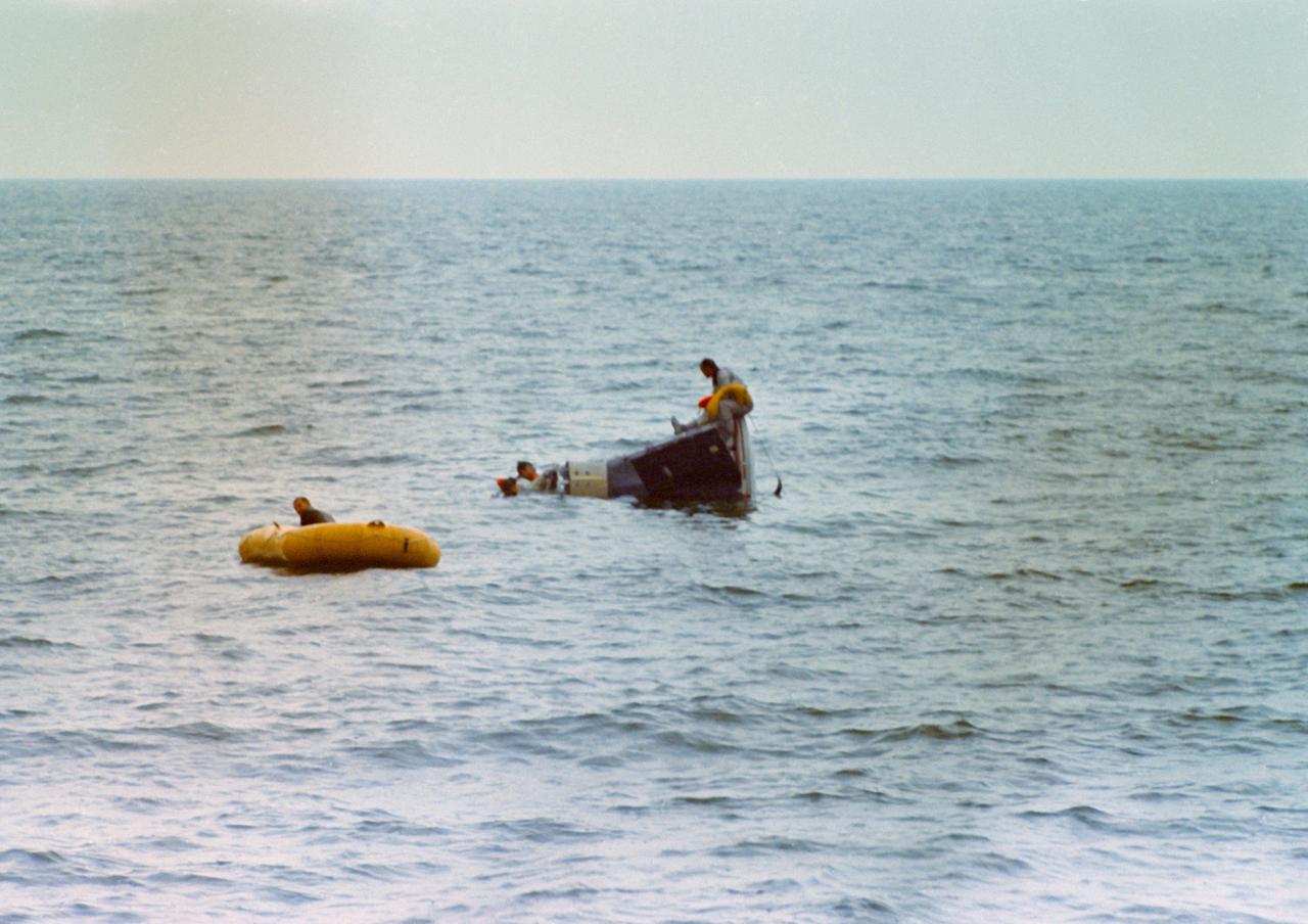 S66-39699 (18 June 1966) --- Astronauts John W. Young (in water, nose of spacecraft), Gemini-10 command pilot, and Michael Collins (sitting on spacecraft), pilot, use Static Article 6 spacecraft during water egress training in the Gulf of Mexico. A team of Manned Spacecraft Center (MSC) swimmers assisted in the training exercise. Photo credit: NASA