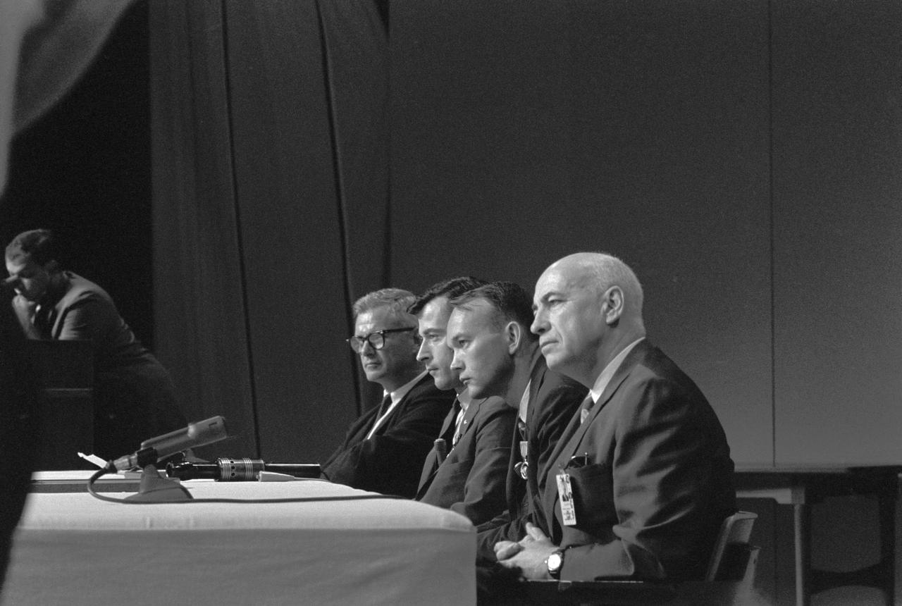 S66-39895 (1 Aug. 1966) --- Panel members of the Gemini-10 news conference held in the Building 1 auditorium were (from left) Dr. Robert C. Seamans Jr., NASA Deputy Administrator; astronaut John W. Young, Gemini-10 command pilot; astronaut Michael Collins, Gemini-10 pilot; and Dr. Robert R. Gilruth, MSC Director. Photo credit: NASA