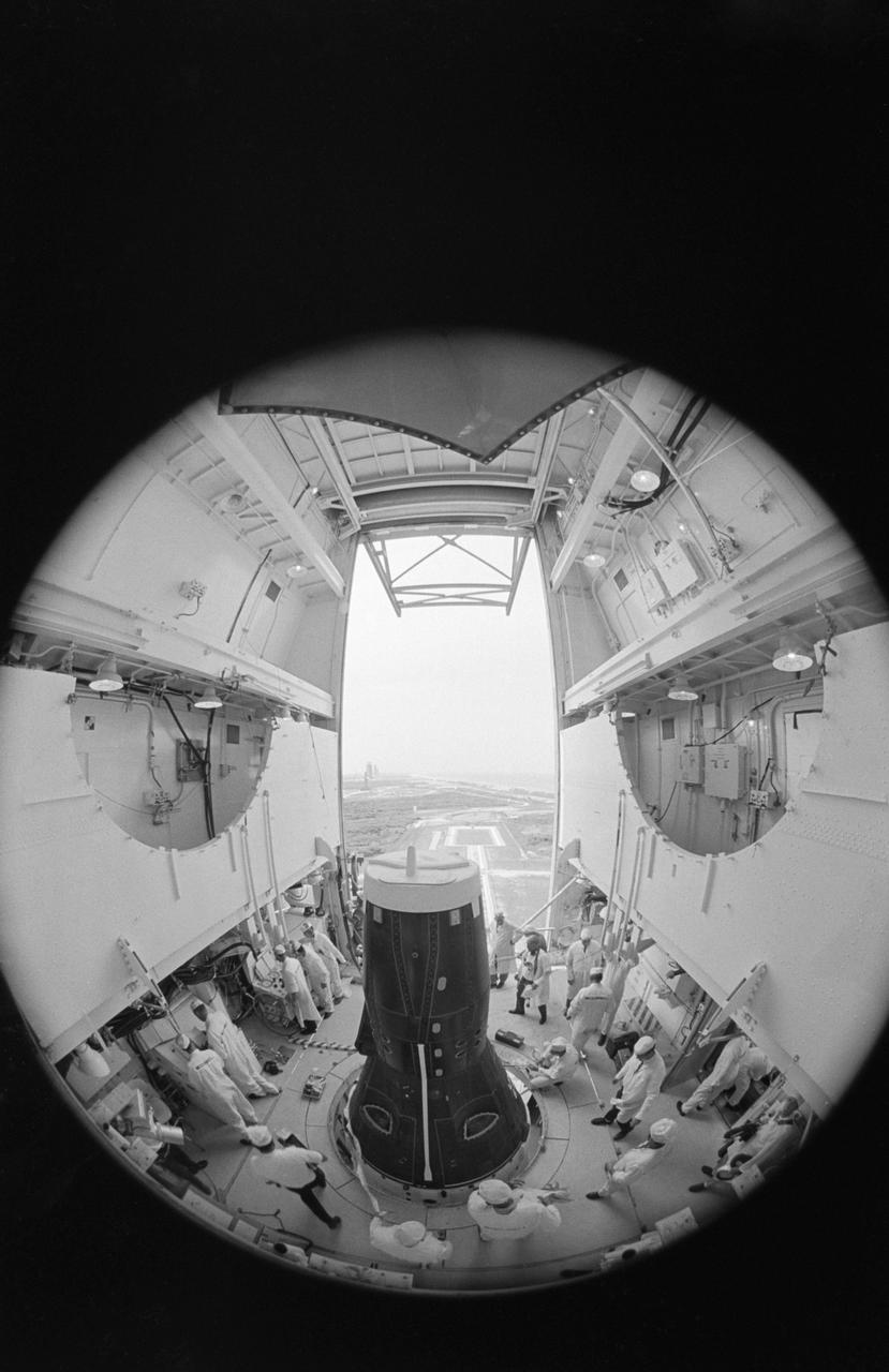 S66-42736 (18 July 1966) --- Fisheye camera lens view of activity in white room atop Pad 19 as technicians secure equipment in preparation for erector lowering. Inside the Gemini-10 spacecraft are astronauts John W. Young, command pilot, and Michael Collins, pilot. Liftoff was at 5:20 p.m. (EST), July 18, 1966. Photo credit: NASA