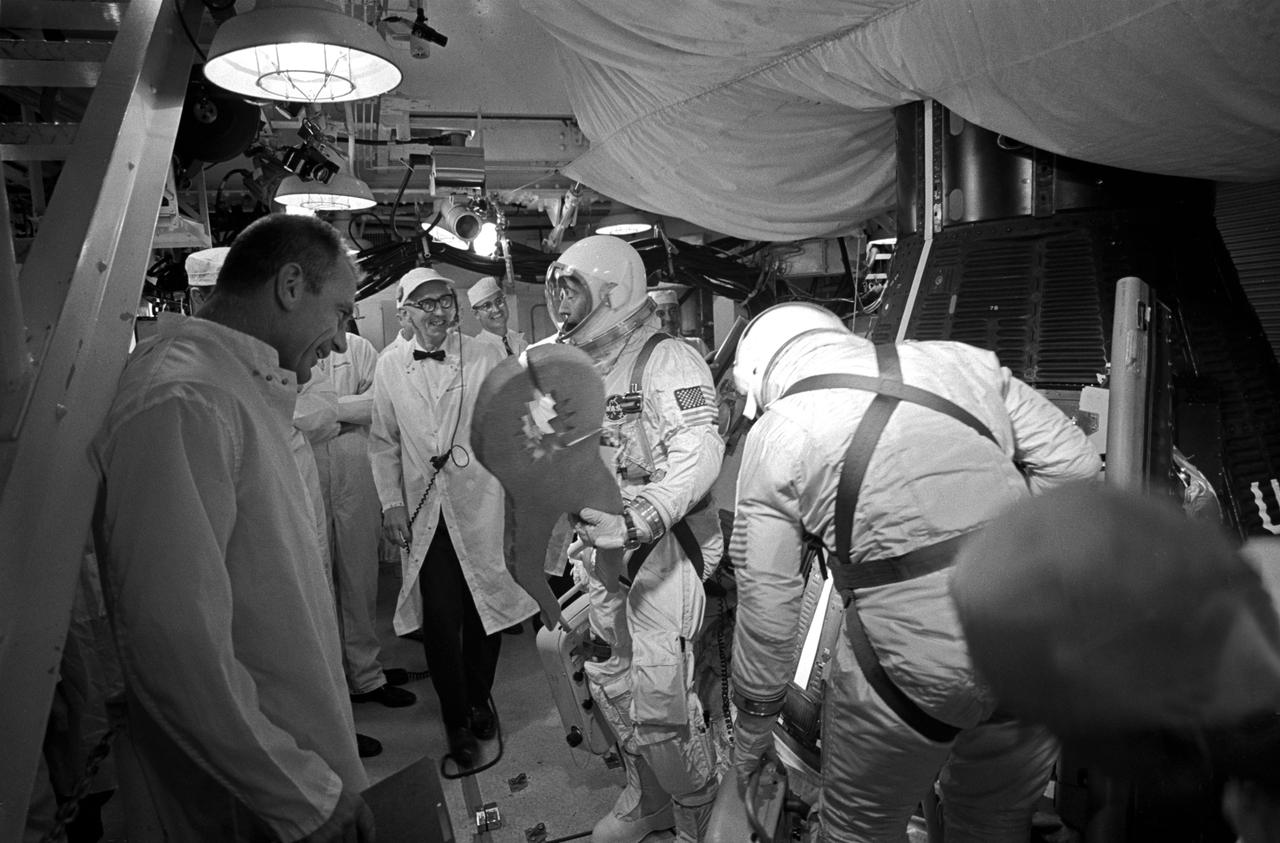 S66-42738 (18 July 1966) --- Astronaut John W. Young, Gemini-10 command pilot, holds a pair of king-size pliers presented to him by the crew at Pad 19 for in-flight first-echelon maintenance of a spacecraft utility power cord Young earlier had difficulty in connecting. Gunther Wendt (right center background), Pad 19 leader, jokes with Young about the pliers. At right is Dr. Donald K. Slayton, MSC Director of Flight Crew Operations. At left is astronaut Michael Collins, Gemini-10 pilot. Photo credit: NASA