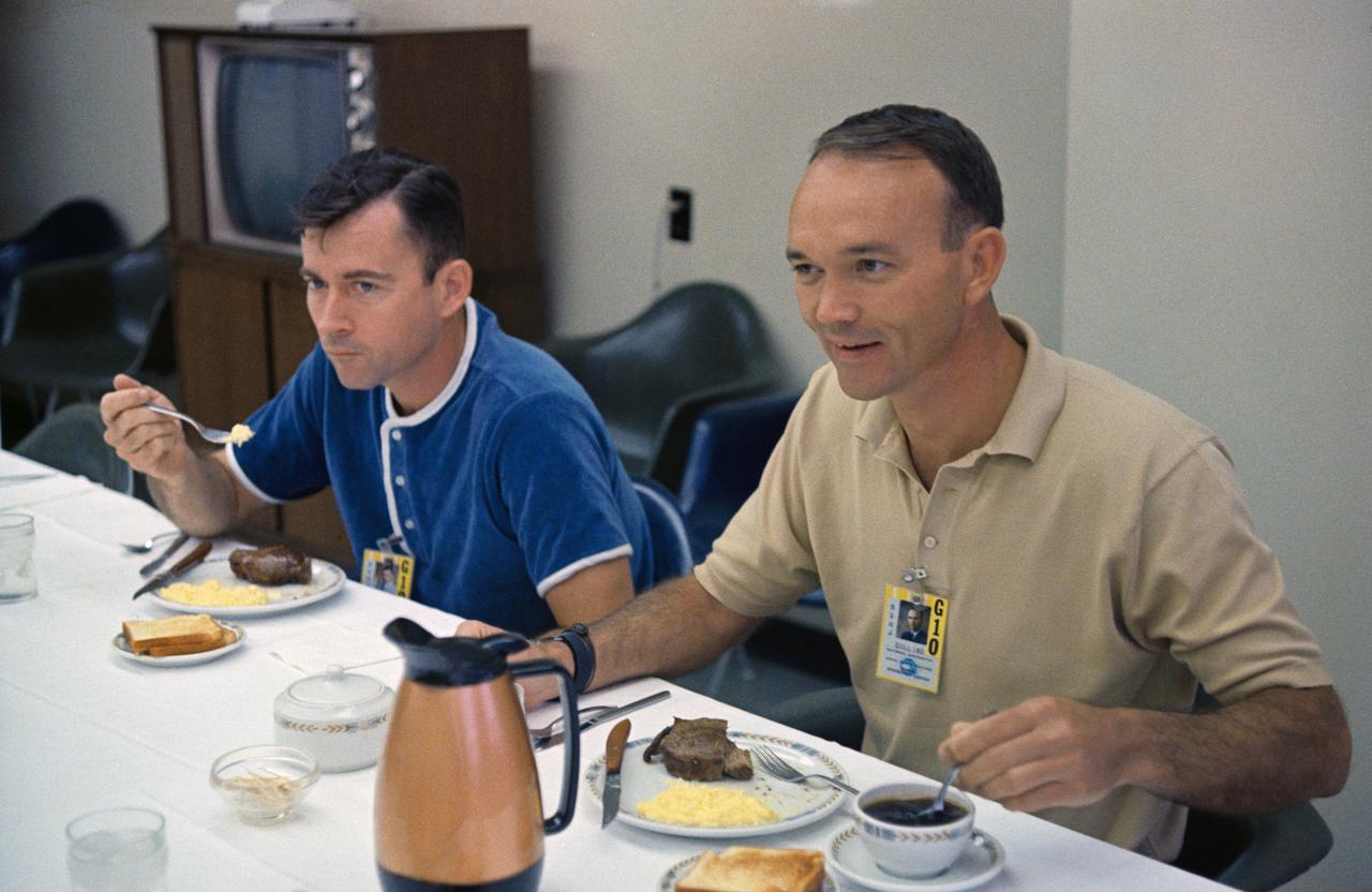 S66-42748 (18 July 1966) --- The Gemini-10 prime crew, astronauts John W. Young (left), command pilot, and Michael Collins, pilot, enjoy a breakfast of steak and eggs on the day of the Gemini-10 launch. The Gemini-10 liftoff was at 5:20 p.m. (EST), July 18, 1966. Photo credit: NASA