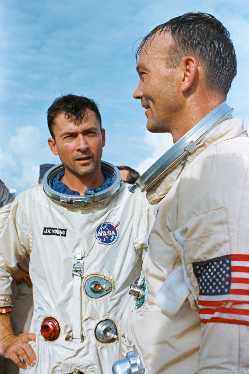 S66-42777 (21 July 1966) --- The crew of the Gemini-10 spaceflight, astronaut John W. Young (left), command pilot, and Michael Collins, pilot, aboard the recovery ship USS Guadalcanal. The astronauts were picked up from the ocean, following a successful splashdown, by a recovery helicopter and flown to the Guadalcanal to begin postflight medical and technical debriefings. Photo credit: NASA