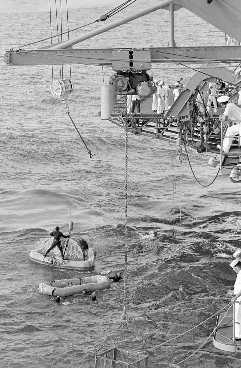 S66-42790 (21 July 1966) --- The Gemini-10 spacecraft, with flotation collar still attached, is prepared for hoisting aboard the prime recovery ship, USS Guadalcanal. Navy frogmen assist in the recovery operations. Astronauts John W. Young, command pilot, and Michael Collins, pilot, prime crew for the Gemini-10 spaceflight, had already been picked up by helicopter and flown to the Guadalcanal. Gemini-10 splashed down 460 nautical miles east of Cape Kennedy at 4:07 p.m. (EST), July 21, 1966, to conclude a three-day mission in space. Photo credit: NASA