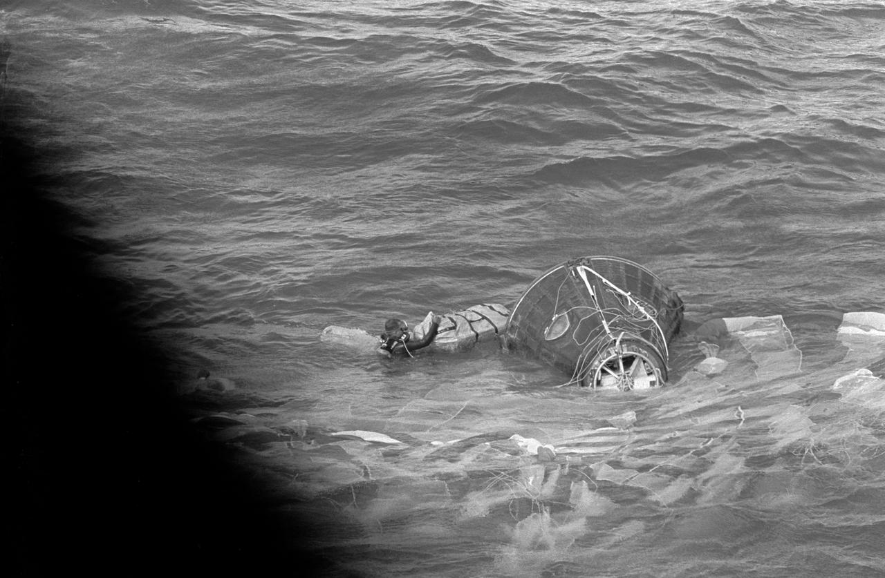S66-42794 (21 July 1966) --- Navy frogmen prepare to attach a flotation collar to the Gemini-10 spacecraft as it bobs in the Atlantic Ocean following its successful splashdown. Inside the spacecraft are astronauts John W. Young, command pilot, and Michael Collins, pilot, waiting to egress the spacecraft for recovery by helicopter from the prime recovery ship, USS Guadalcanal. Photo credit: NASA