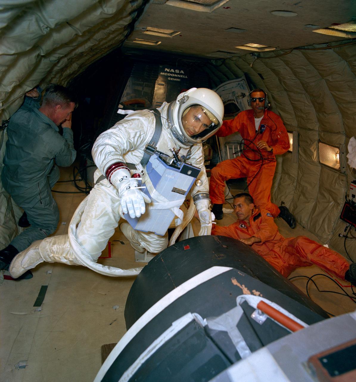 S66-47856 (11 Aug. 1966) --- Astronaut William A. Anders, backup crew pilot of the Gemini-11 spaceflight, participates in extravehicular activity (EVA) training under zero-gravity conditions aboard a KC-135 aircraft from Wright-Patterson Air Force Base, Dayton, Ohio. He is suited, and he also wears an Extravehicular Life Support System (ELSS) chest pack. Photo credit: NASA