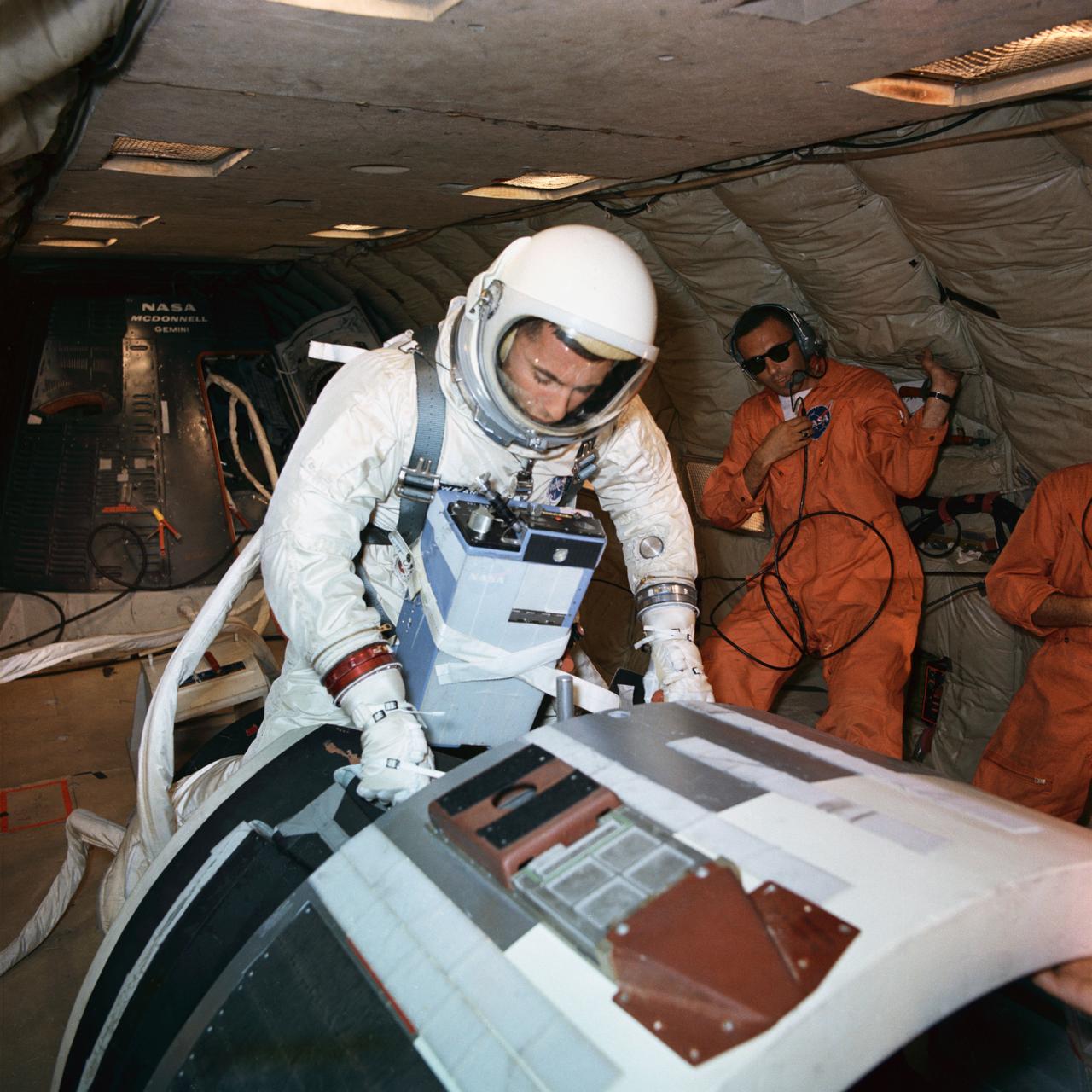 S66-47857 (11 Aug. 1966) --- Astronaut William A. Anders, backup crew pilot of the Gemini-11 spaceflight, participates in extravehicular activity (EVA) training under zero-gravity conditions aboard a KC-135 aircraft from Wright-Patterson Air Force Base, Dayton, Ohio. He is suited, and he also wears an Extravehicular Life Support System (ELSS) chest pack. Photo credit: NASA