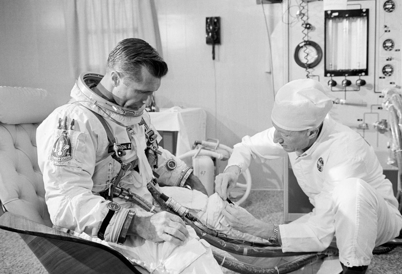 S66-50816 (12 Sept. 1966) --- Astronaut Richard F. Gordon Jr., pilot of the Gemini-11 spaceflight, undergoes suiting up operations in the Launch Complex 16 suit trailer during the Gemini-11 prelaunch countdown. At right is suit technician Clyde Teague. Later, astronaut Gordon and Charles Conrad Jr., command pilot, entered a transport van which carried them to Pad 19 and their waiting spacecraft. The liftoff was at 9:42 a.m. (EST), Sept. 12, 1966. Photo credit: NASA