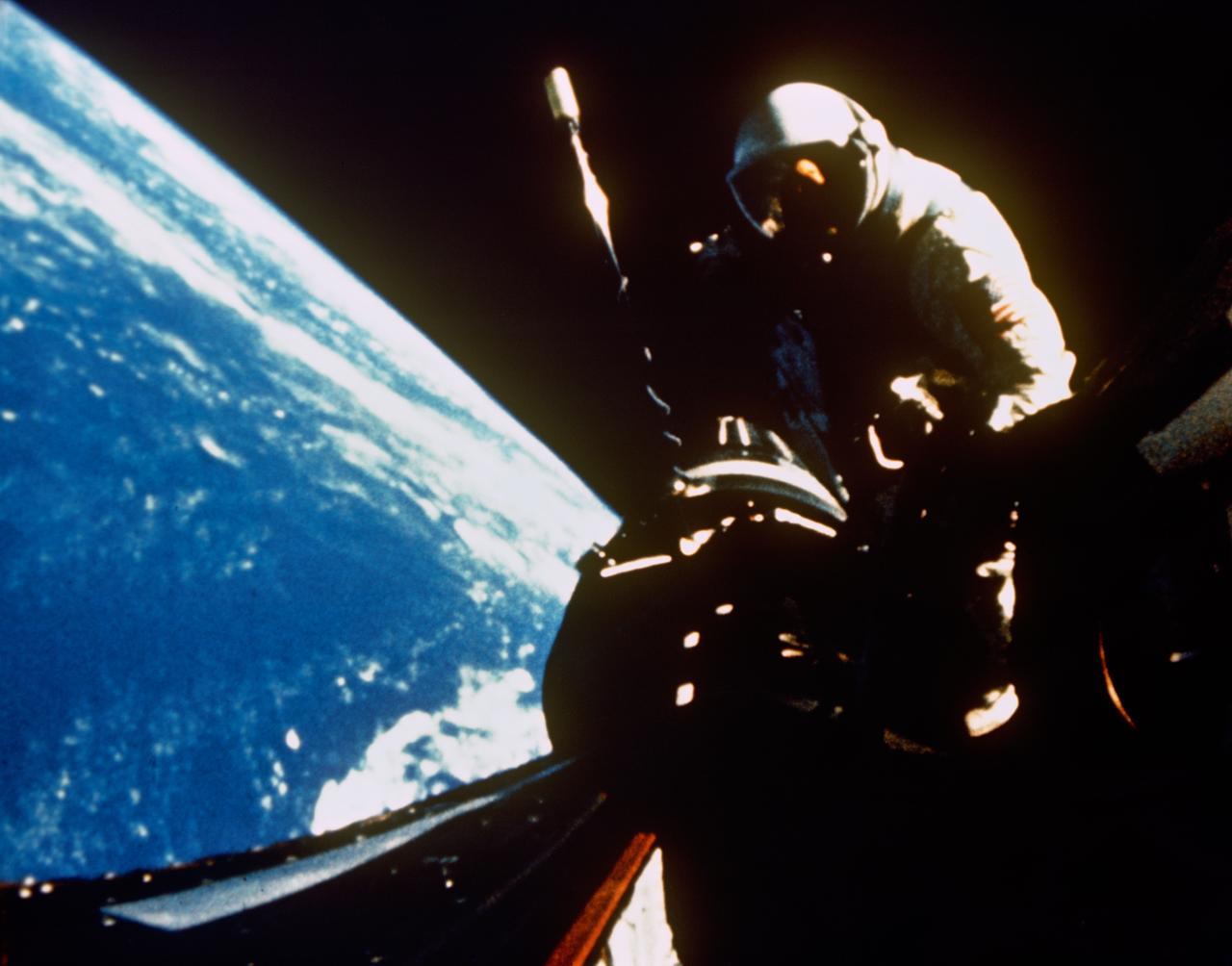 S66-54454 (13 Sept. 1966) --- Astronaut Richard F. Gordon Jr., pilot for the Gemini-11 spaceflight, returns to the hatch of the spacecraft following extravehicular activity (EVA). This picture was taken over the Atlantic Ocean at approximately 160 nautical miles above Earth's surface. Photo credit: NASA