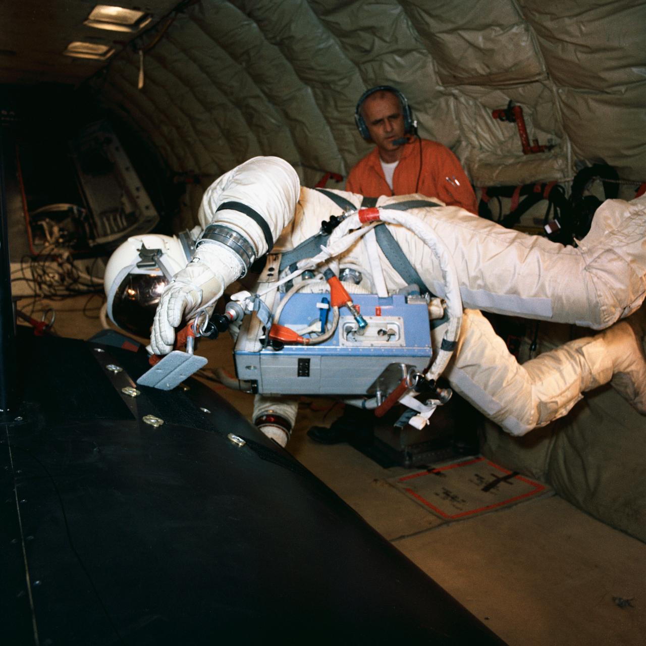 S66-57353 (13 Oct. 1966) --- Astronaut Edwin E. Aldrin Jr., pilot for the Gemini-12 spaceflight, practices work tasks on a mock-up of the adapter section of a spacecraft. Training took place onboard an Air Force KC-135 jet aircraft. He wears a life support chest pack during the exercise. Photo credit: NASA