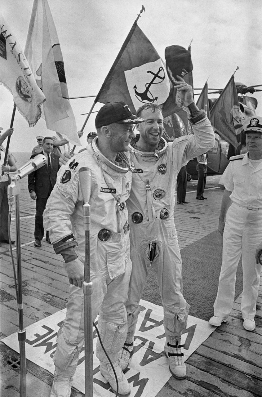 S66-59940 (15 Nov. 1966) --- Astronauts James A. Lovell Jr. (right), command pilot, and Edwin E. Aldrin Jr., pilot, are welcomed aboard the aircraft carrier USS Wasp after their Gemini-12 spacecraft splashed down in the Atlantic Ocean recovery area at 2:21 p.m. (EST), Nov. 15, 1966, to conclude a four-day mission in space. Photo credit: NASA