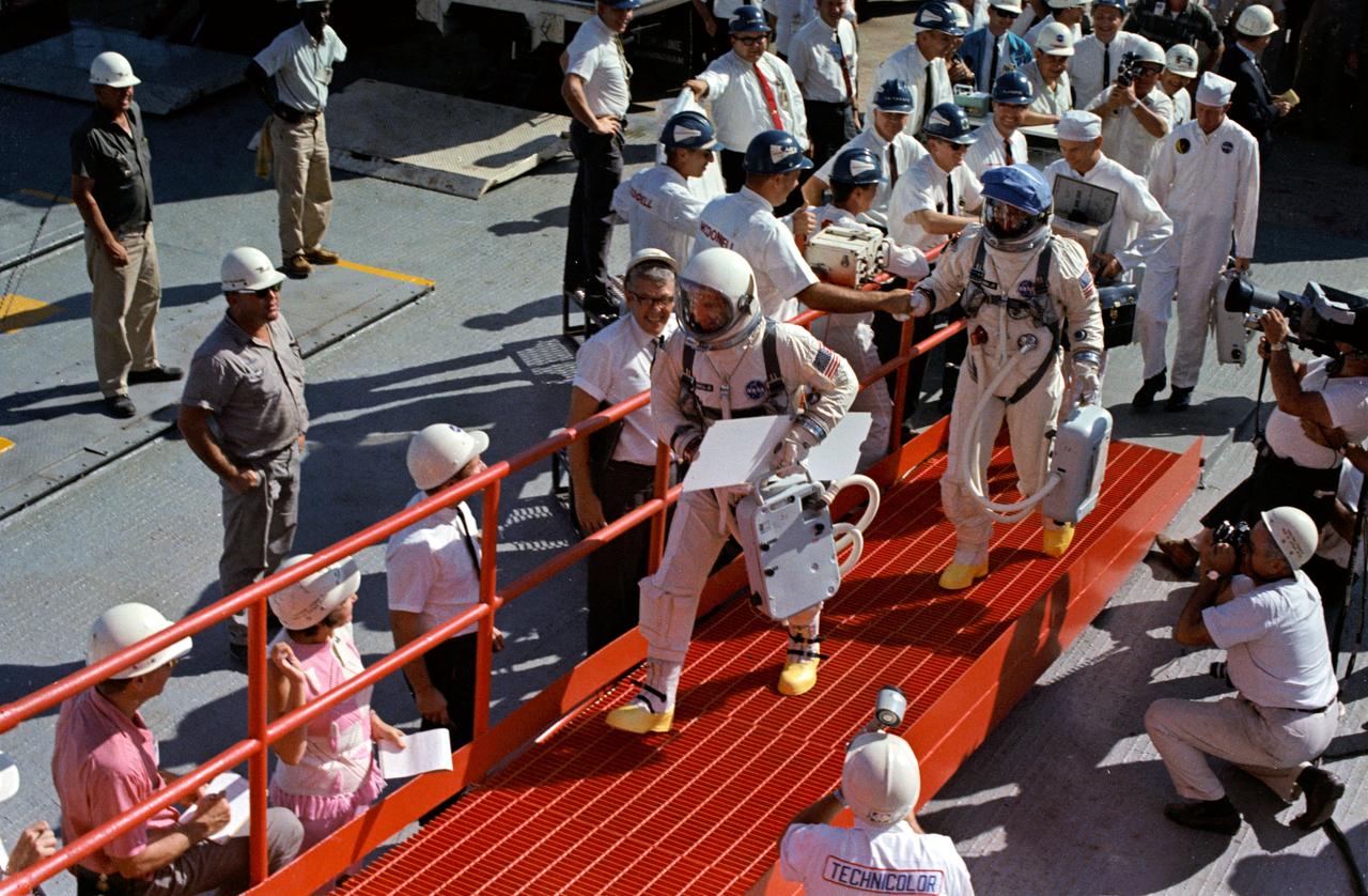 S66-59966 (11 Nov. 1966) --- Astronauts James A. Lovell Jr. (leading), command pilot, and Edwin E. Aldrin Jr., pilot, walk up the ramp at Pad 19 after arriving from the Launch Complex 16 suiting trailer during the prelaunch countdown. Moments later they entered the elevator which took them to the white room and the waiting Gemini-12 spacecraft. Liftoff was at 3:46 p.m. (EST), Nov. 11, 1966. Photo credit: NASA