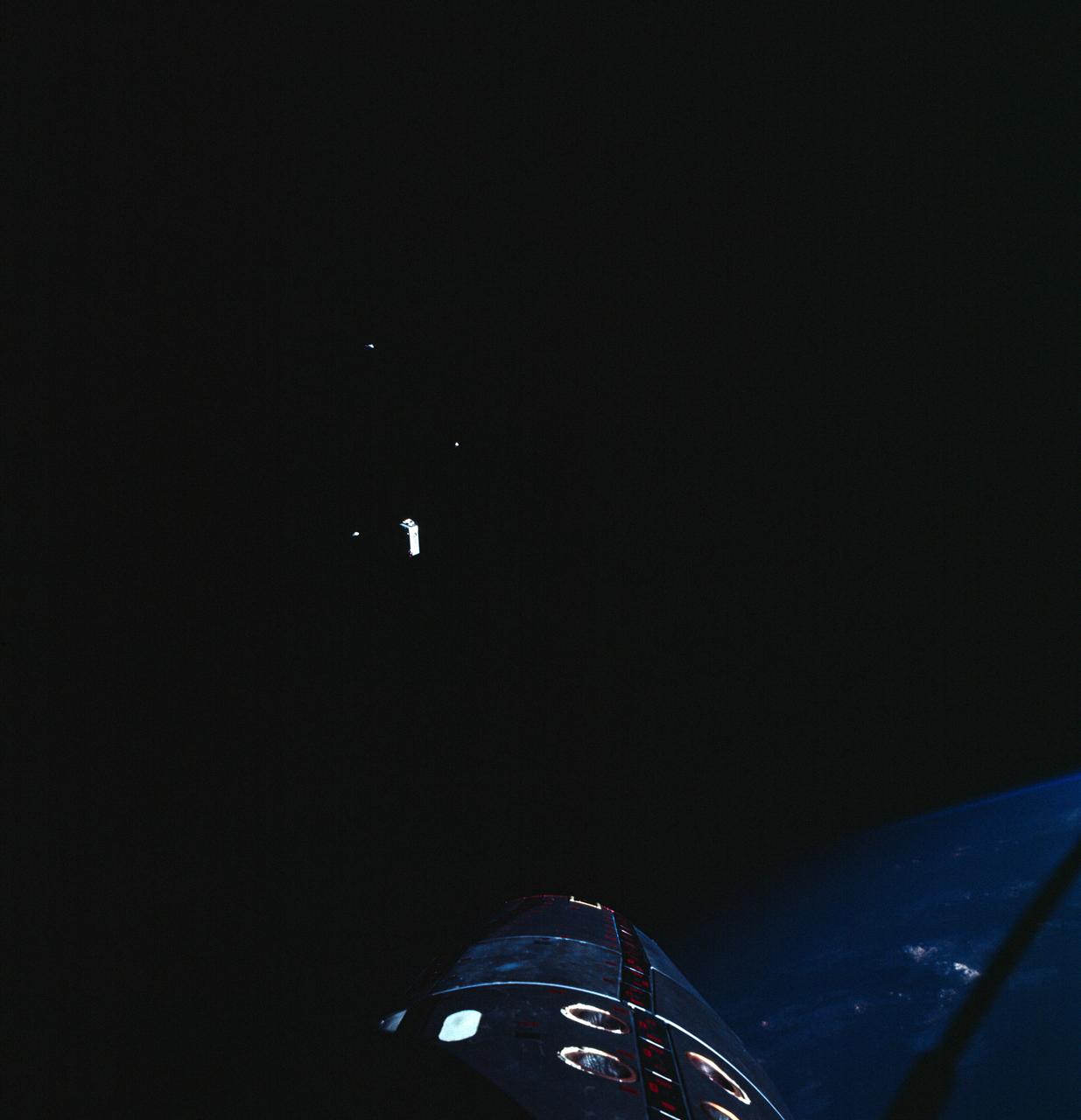 S66-62999 (13 Nov. 1966) --- Jettison of the extravehicular life support system (ELSS) and other equipment from the Gemini-12 spacecraft during its rendezvous mission in space. The nose of the Gemini-12 spacecraft is clearly visible at right edge of photo. Photo credit: NASA