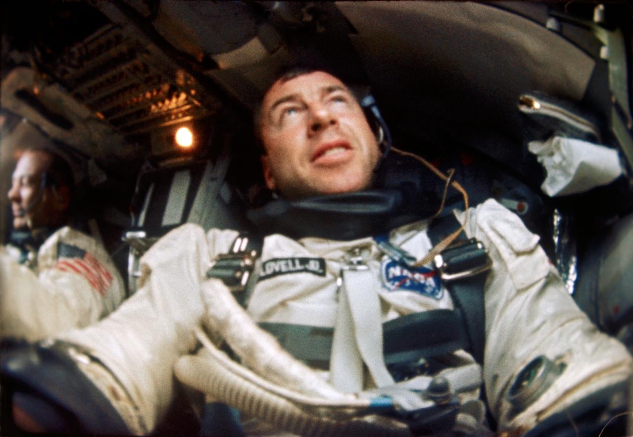 S66-63540 (12 Nov. 1966) --- Astronaut James A. Lovell is photographed inside his Gemini spacecraft during the Gemini-12 mission. Astronaut Edwin Aldrin is seen in the background and to the left. Photo credit: NASA