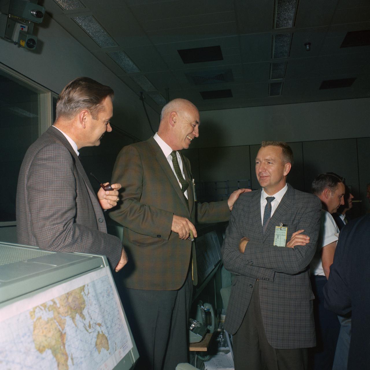 S66-64870 (15 Nov. 1966) --- Dr. Robert R. Gilruth (center) talks to other NASA officials in Mission Control Center near the end of the Gemini-12 mission. Photo credit: NASA