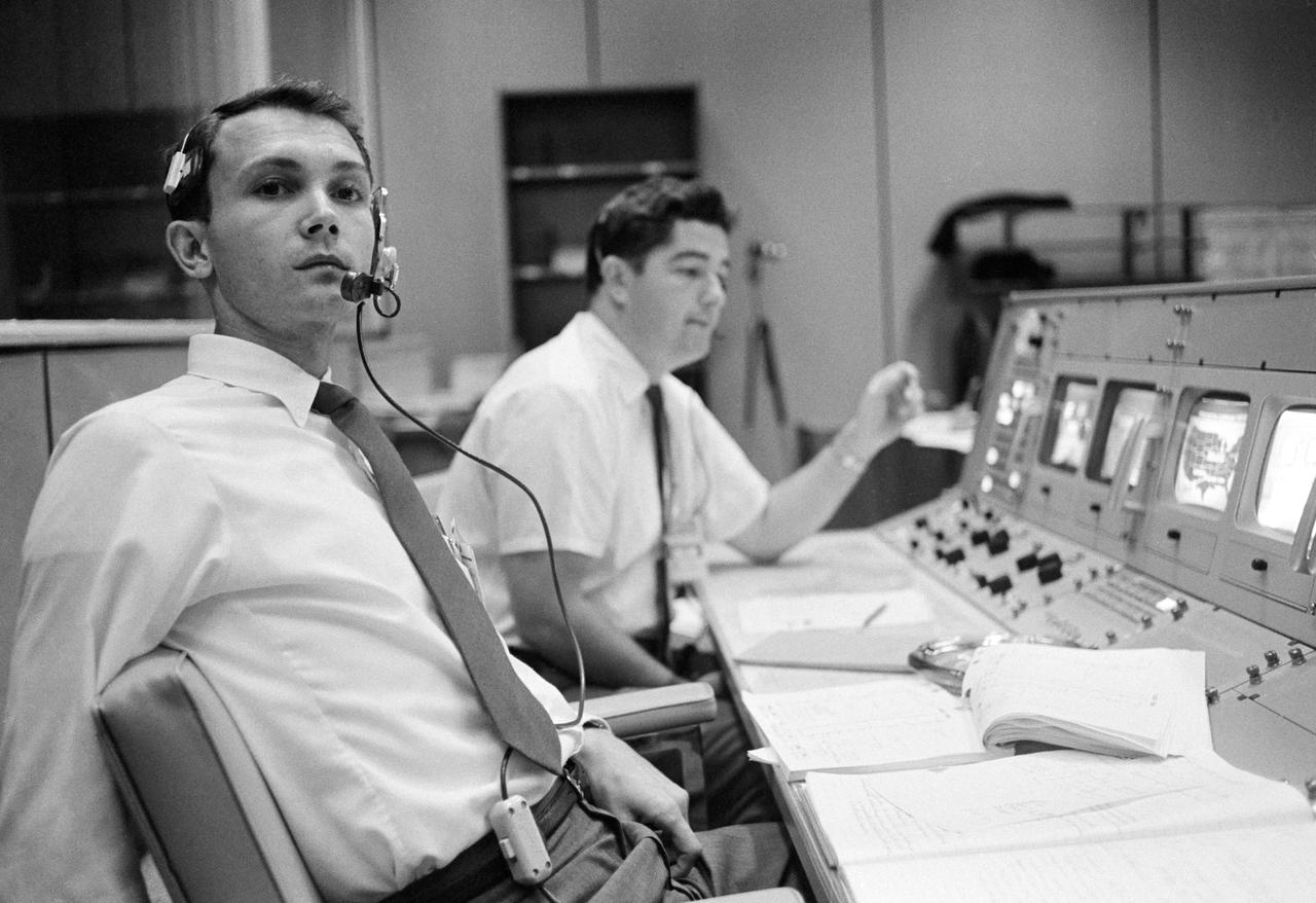 S68-50696 (October 1968) --- Public Affairs Office (PAO) commentator Douglas K. Ward (foreground) is pictured at his console in the Mission Operations Control Room (MOCR) in the Mission Control Center at NASA's Johnson Space Center during the flight of Apollo 7. Photo credit: NASA