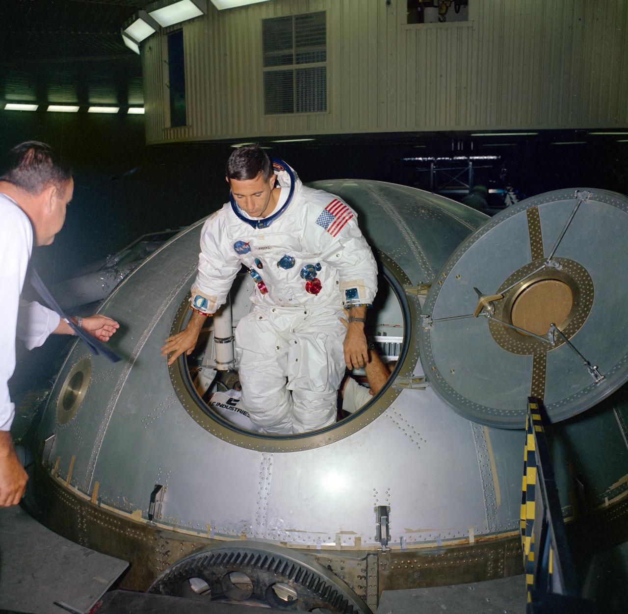 Apollo 8 astronaut William A. Anders, lunar module pilot, steps out of the centrifuge gondola in bldg 29 during centrifuge training in the Manned Spacecraft Center's (MSC) Flight Acceleration Facility.