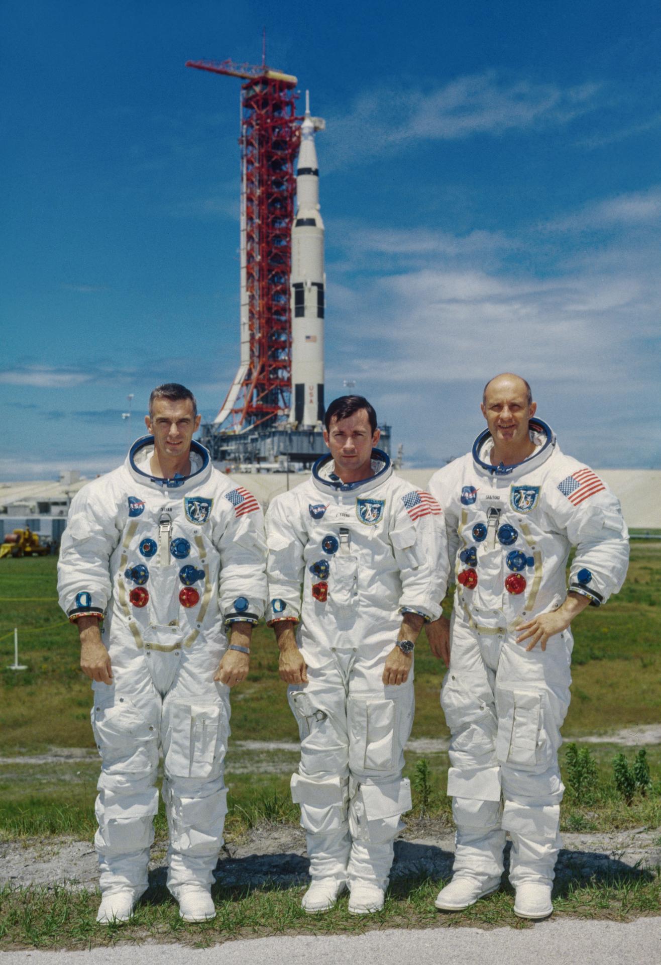 Portrait of the Apollo 10 prime crew wearing their space suits in front of the Saturn V rocket that will take them to space. They are Eugene A. Cernan, lunar module pilot; John W. Young, command module pilot; and Thomas P. Stafford, commander.