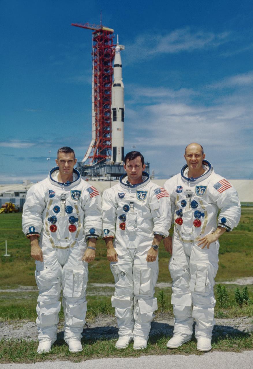 S69-34385 (13 May 1969) --- These three astronauts are the prime crew of the Apollo 10 lunar orbit mission. Left to right, are Eugene A. Cernan, lunar module pilot; John W. Young, command module pilot; and Thomas P. Stafford, commander. In the background is the Apollo 10 space vehicle on Pad B, Launch Complex 39, Kennedy Space Center, Florida.