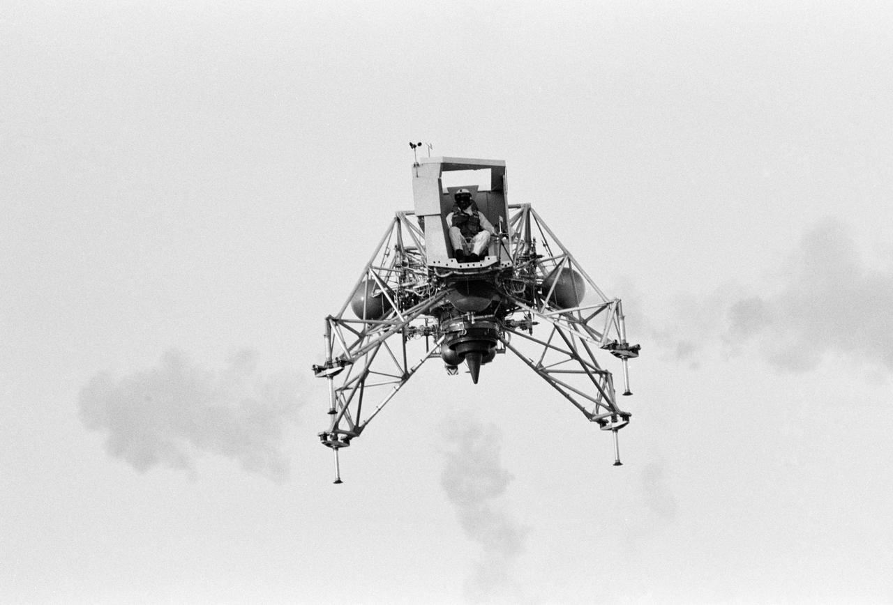 Inflight view of Astronaut Neil Armstrong flying the Lunar Landing Training Vehicle (LLTV) at EAFB.  EAFB, Houston, TX