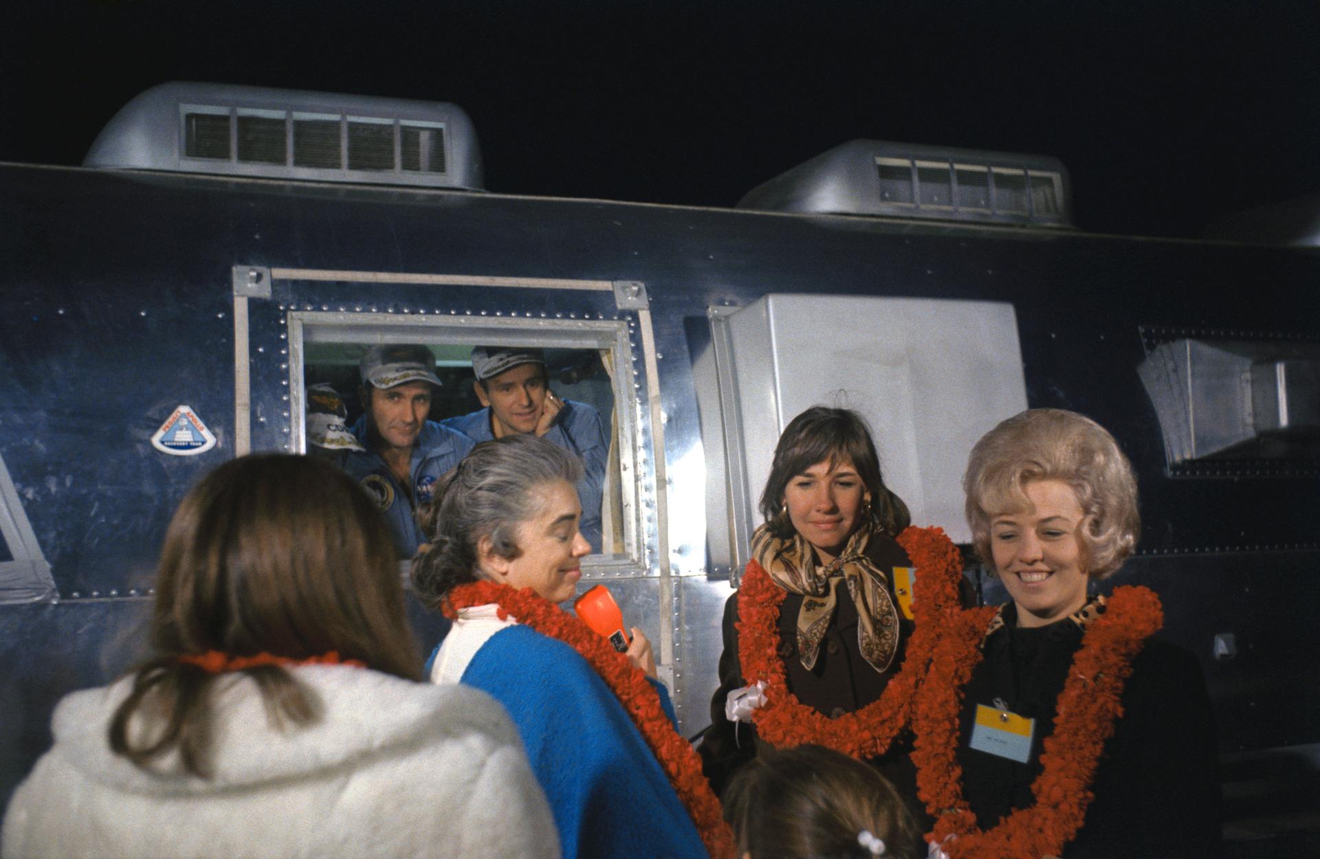 The wives of the Apollo 12 crew visit with them while they are in quarantine