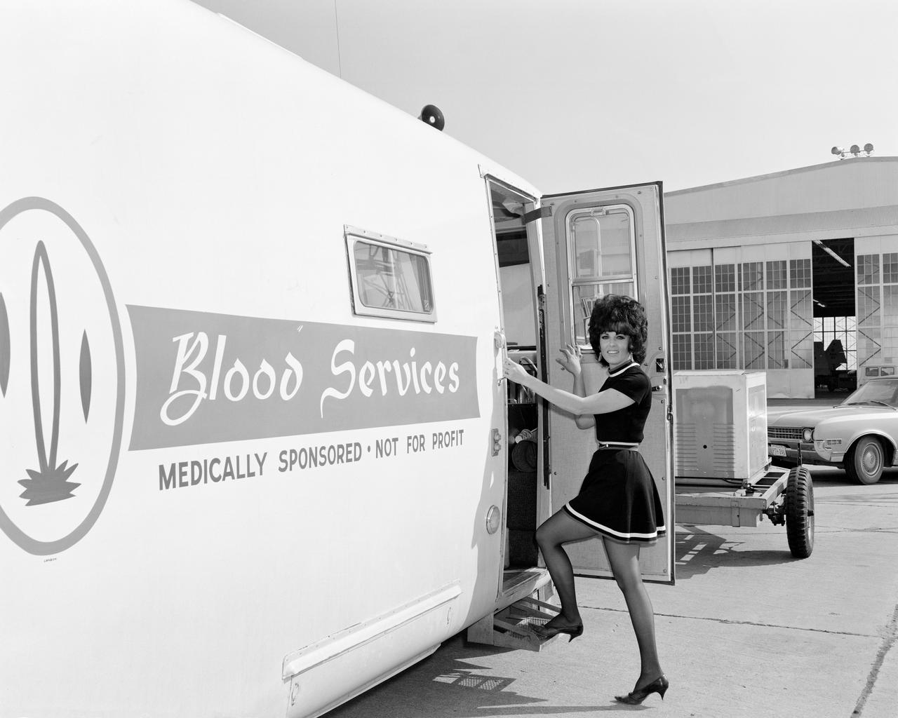 View of donor Cathy Cannon, employee of Lockheed, entering the bloodmobile, at Ellington AFB.