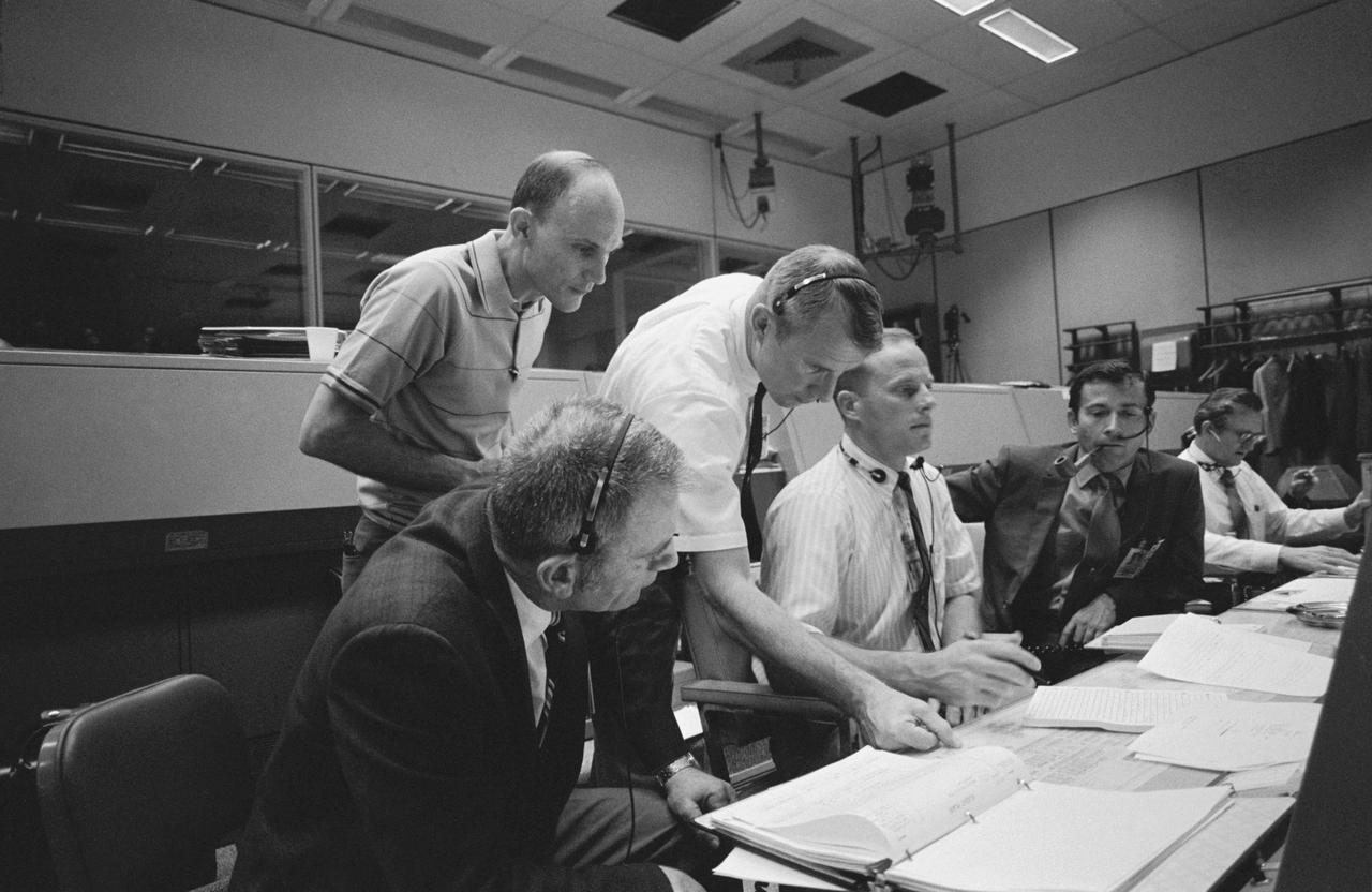 S70-34902 (14 April 1970) --- Several persons important to the Apollo 13 mission, at consoles in the Mission Operations Control Room (MOCR) of the Mission Control Center (MCC).  Seated at consoles, from left to right, are astronauts Donald K. Slayton, director of flight crew operations; astronaut Jack R. Lousma, Shift 3 spacecraft communicator; and astronaut John W. Young, commander of the Apollo 13 backup crew.  Standing, left to right, are astronaut Tom K. Mattingly II, who was replaced as Apollo 13 command module pilot after it was learned he may come down with measles, and astronaut Vance D. Brand, Shift 2 spacecraft communicator.  Several hours earlier, in the late evening hours of April 13, crew members of the Apollo 13 mission reported to MCC that trouble had developed with an oxygen cell on their spacecraft.