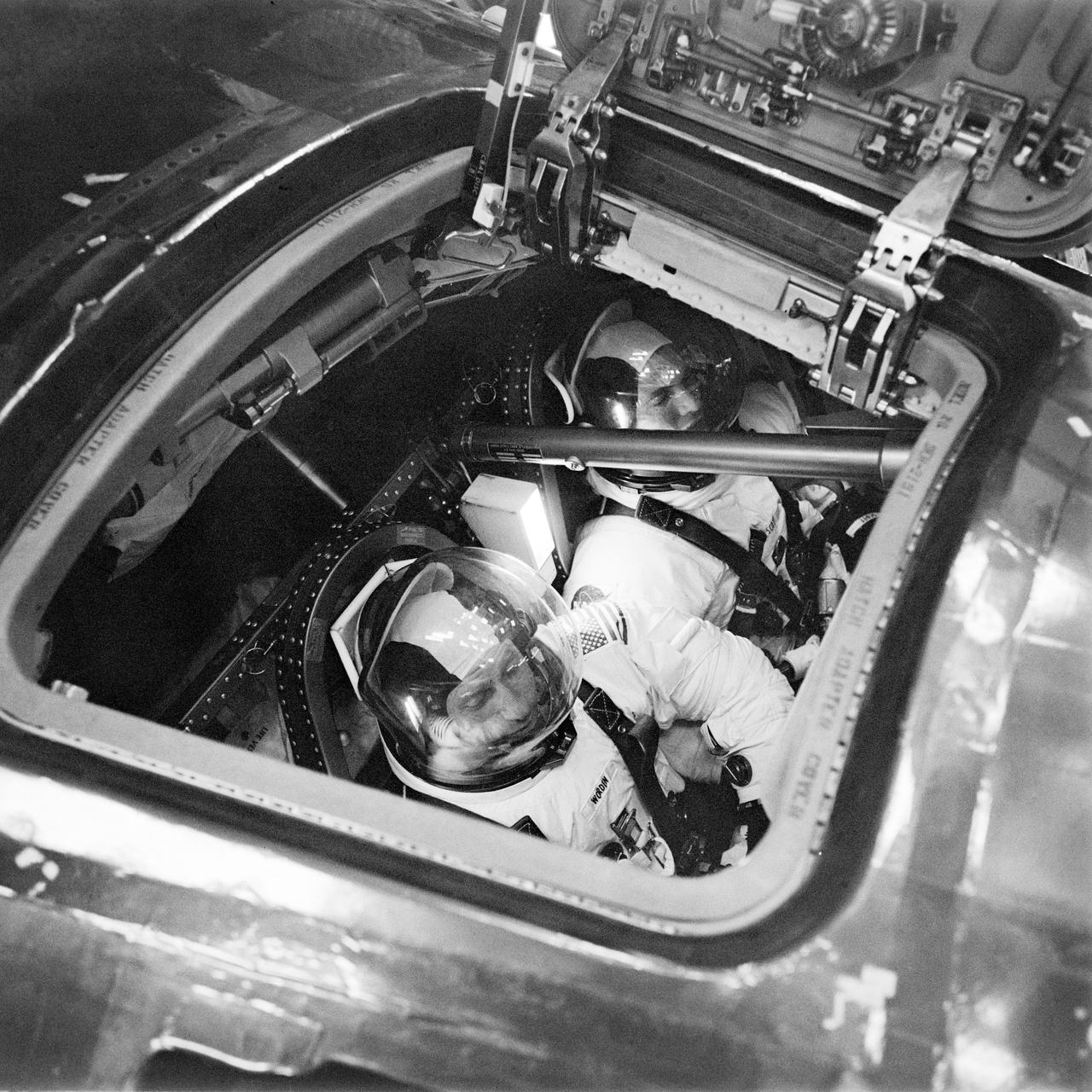 S71-29951 (26 March 1971) --- Two Apollo 15 prime crew members can be seen inside the Apollo 15 Command Module (CM) during simulation training at the Kennedy Space Center (KSC).  Astronaut David R. Scott, commander, is in the background.  Astronaut Alfred M. Worden, foreground, is the command module pilot.  Out of view is astronaut James B. Irwin, lunar module pilot.
