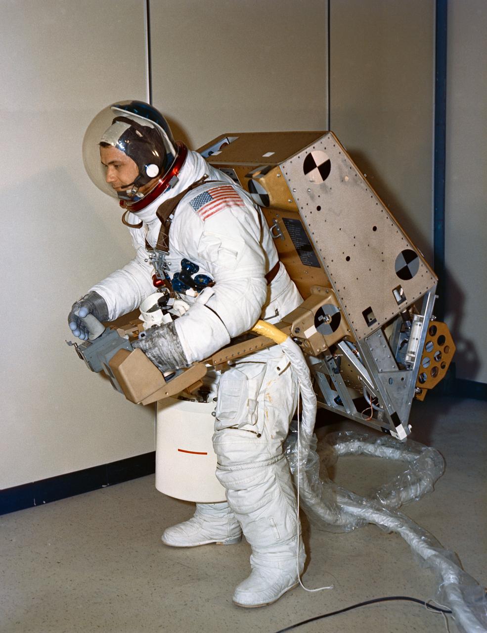 S72-30704 (1972) --- Astronaut Bruce McCandless II, backup pilot for Skylab 2, tests the balance and control of an astronaut maneuvering unit (AMU) test model at Martin Marietta Corporation's Denver division. The jet-powered backpack can fly for 30 minutes and can be worn over normal clothing or spacesuit. Photo credit: NASA