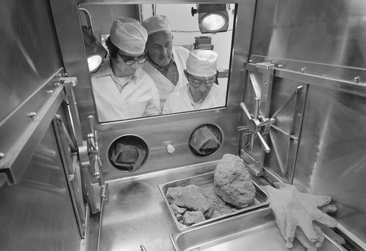 S72-38463  (19 May 1972) --- In an isolated area of the Manned Spacecraft Center's Lunar Receiving Laboratory, geologists Don Morrison (left) and Fred Horz flank University of Texas geologist/professor William (Bill) Muehlberger as the three look at a "special" rock brought back from the moon recently by the Apollo 16 astronauts. Lunar sample 61016, better known as "Big Muley," is a large breccia sample, the largest moon rock returned by any Apollo crew, which is named after Muehlberger, the Apollo 16 field geology team leader. Photo credit: NASA