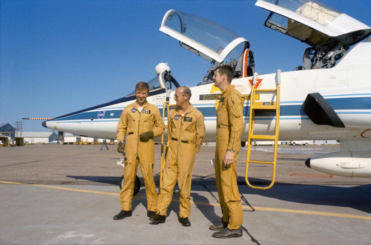 S73-25714 (13 May 1973) --- Members of the prime crew of the first manned Skylab Mission (Skylab 2) stand beside a NASA T-38 jet aircraft trainer at nearby Ellington Air Force Base prior to take off for the Kennedy Space Center, Florida. They are (left to right) astronauts Paul J. Weitz, mission pilot; Charles Conrad Jr., commander; and scientist Joseph P. Kerwin, science pilot. The three crewmen have completed their prelaunch training at JSC. Photo credit: NASA