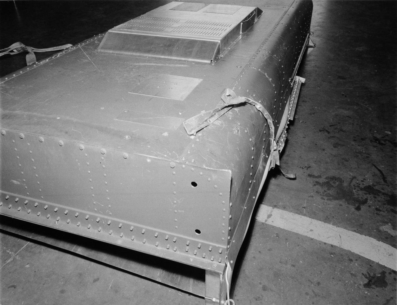 S73-27406 (5 June 1973) --- This structure duplicates the current problem with solar array wing number one on Skylab. The wing is being held against the side of the Orbital Workshop by what appears to be a strip of metal from the Meteoroid shield. Photo credit: NASA
